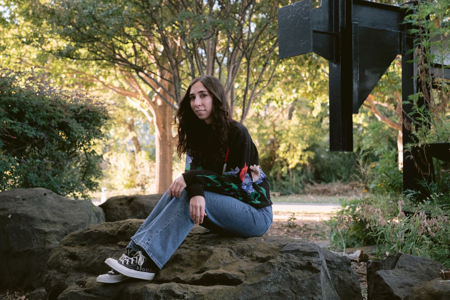 A librarian posing in front of Emily Fowler Library in Denton, TX.