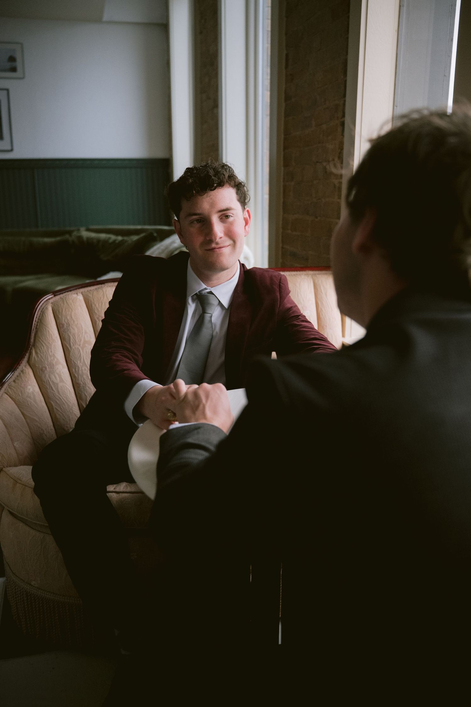 Two grooms looking at each other lovingly