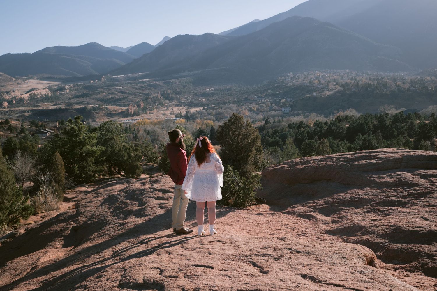 A couple looking out at the mountains at Garden of the Gods Park in Colorado Springs.