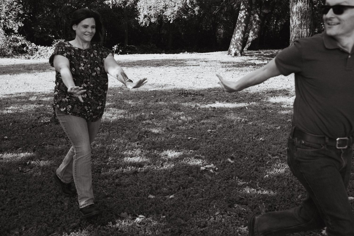 A couple chasing each other in a park in Fort Worth, TX