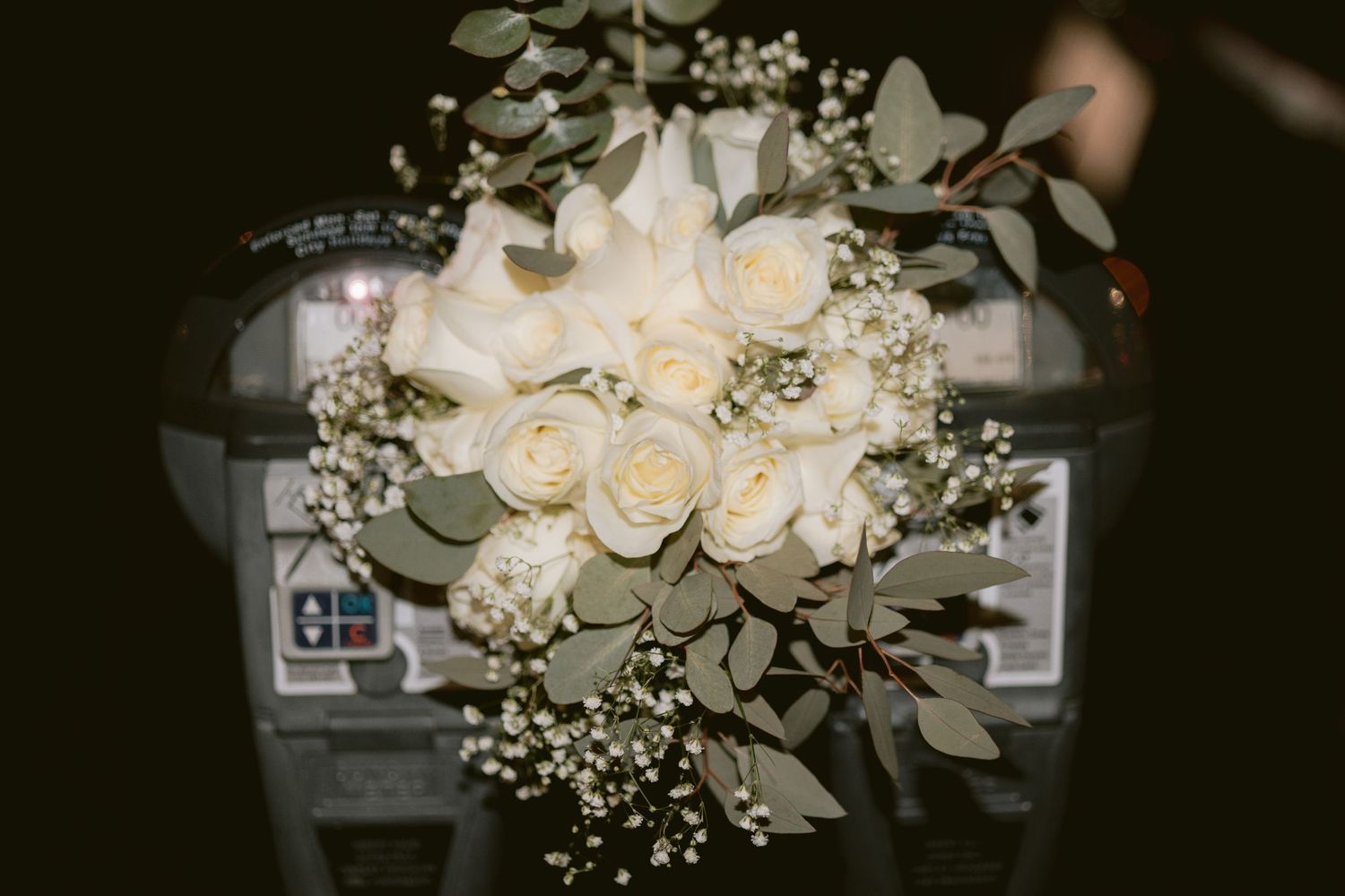 A bridal bouquet on a parking meter