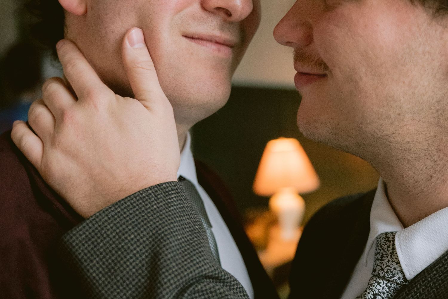 A groom gently touching his husband's cheek