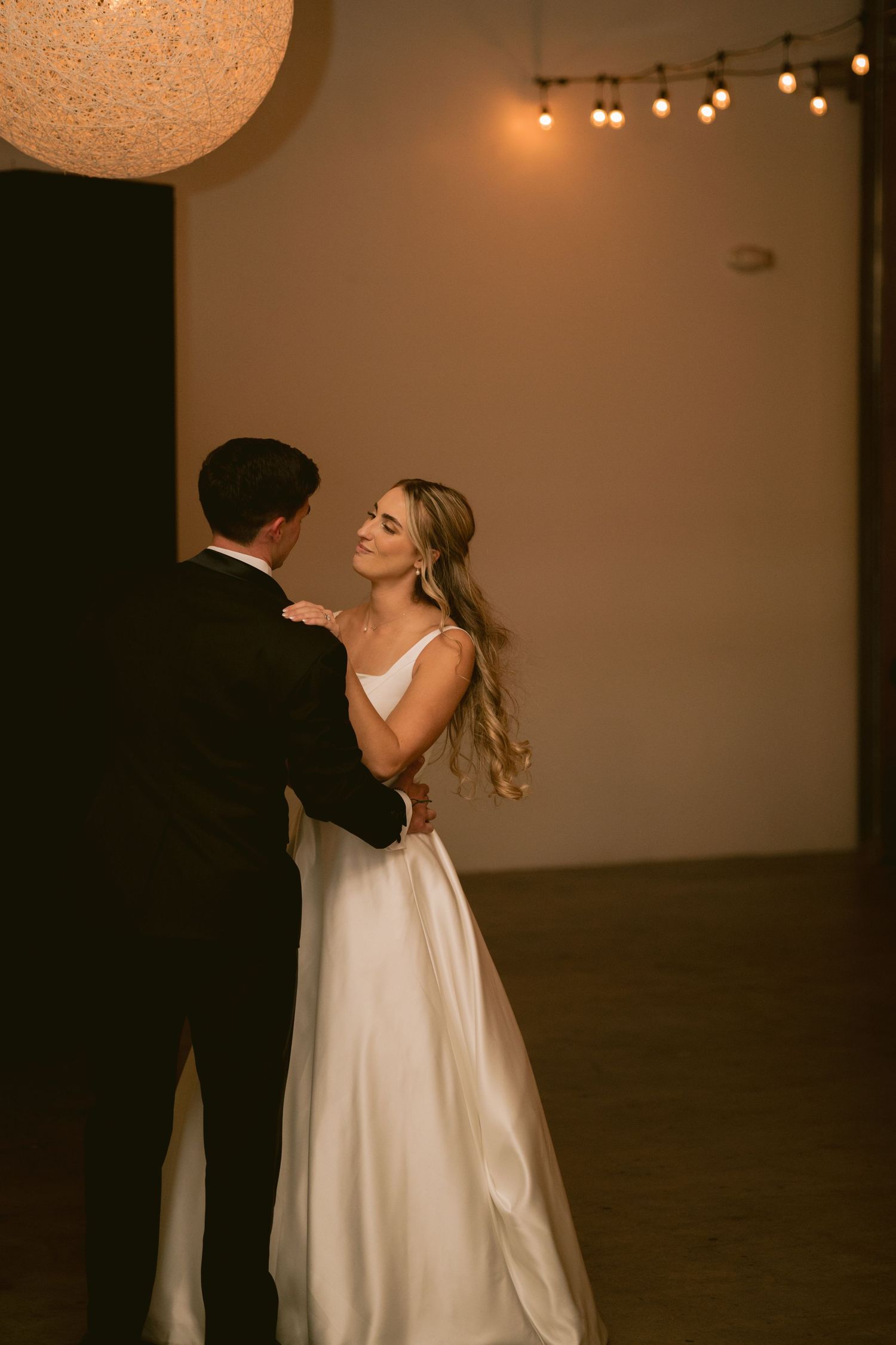 A newlywed couple shares their first dance at Clay Venues in Colorado Springs, CO