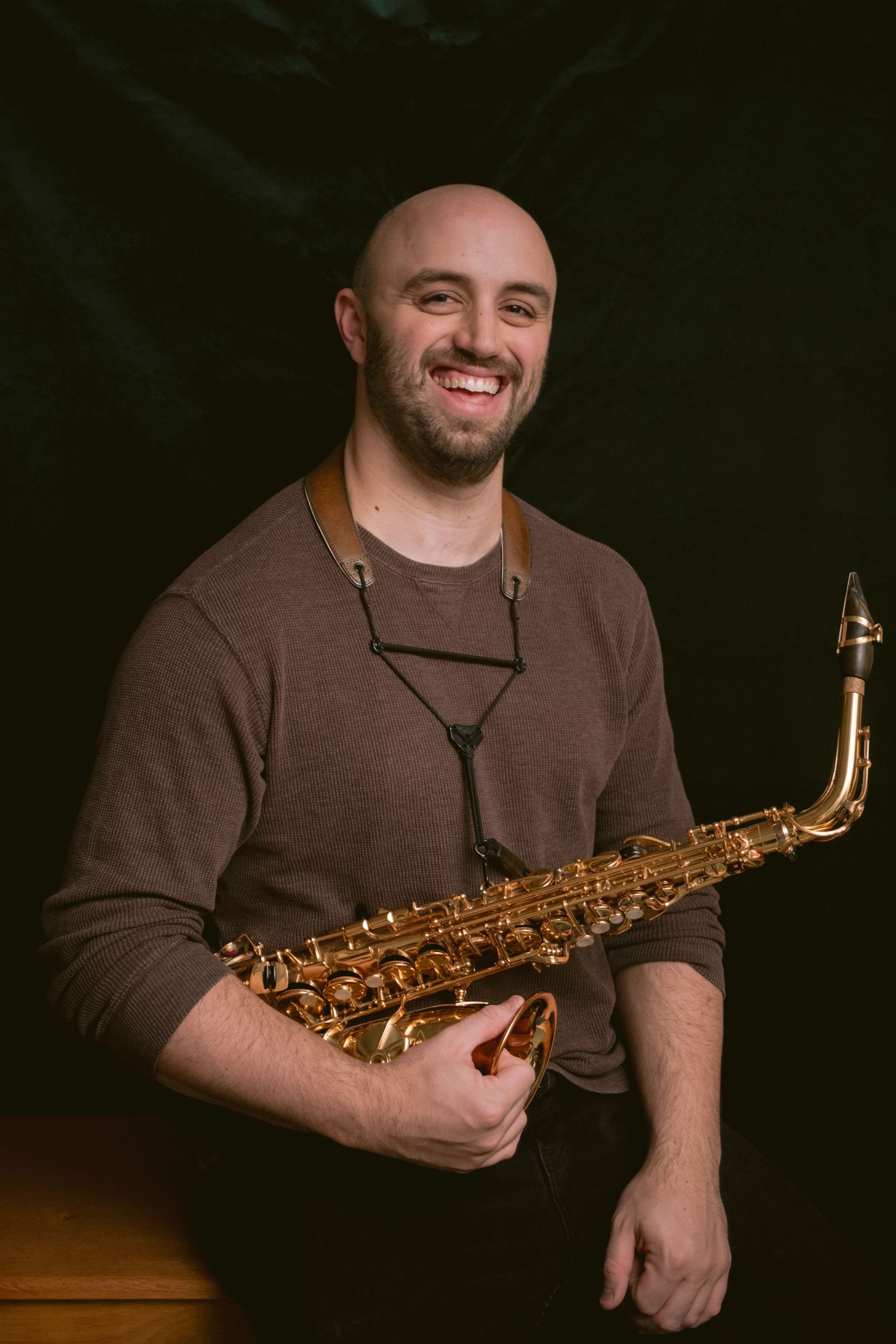 Portrait of a man holding a saxophone