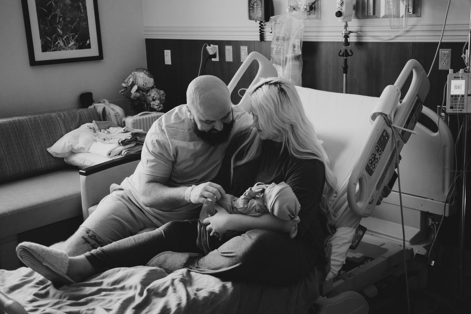 Two new parents holding their newborn son in Fort Worth, TX