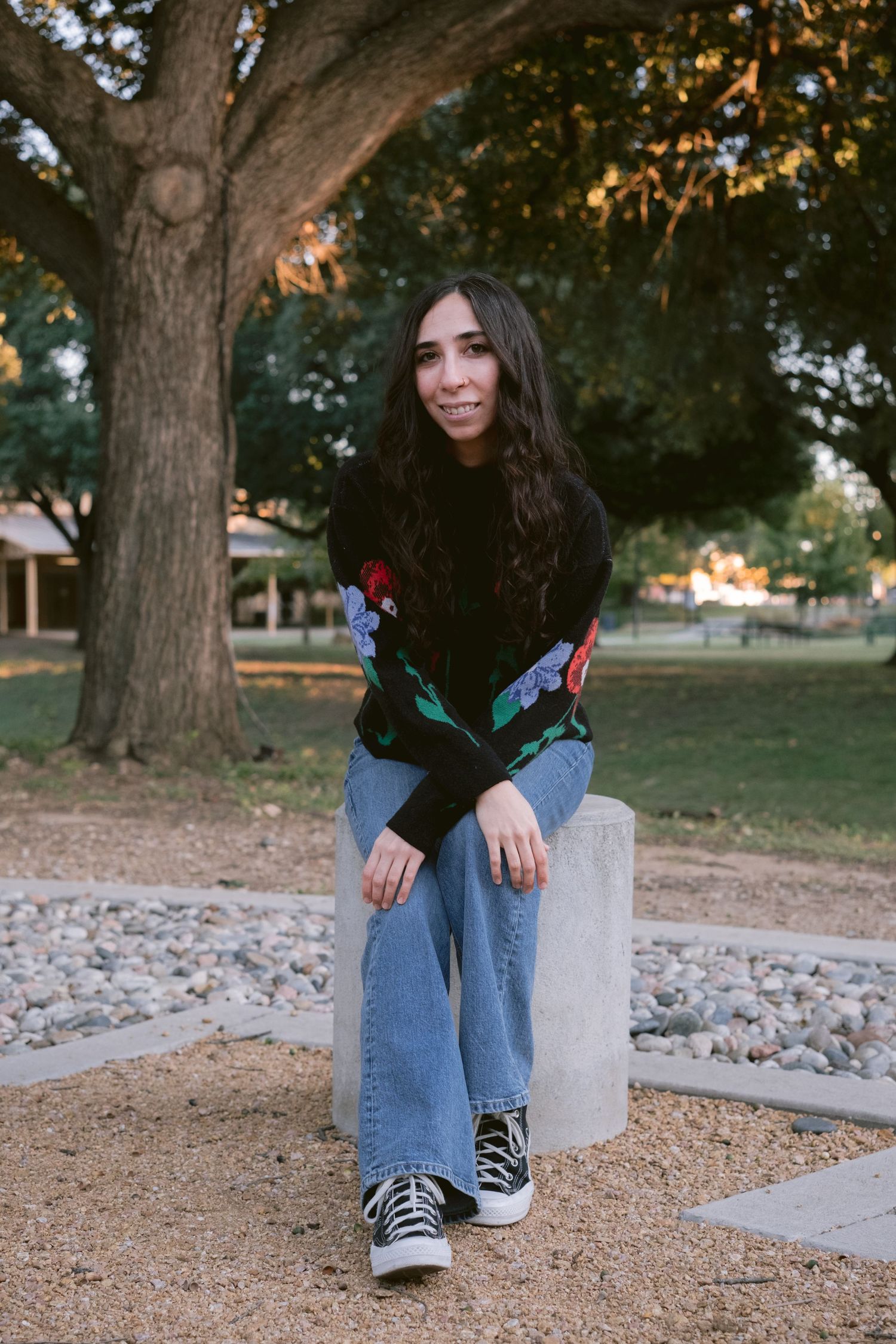 A librarian posing in front of Emily Fowler Library in Denton, TX.