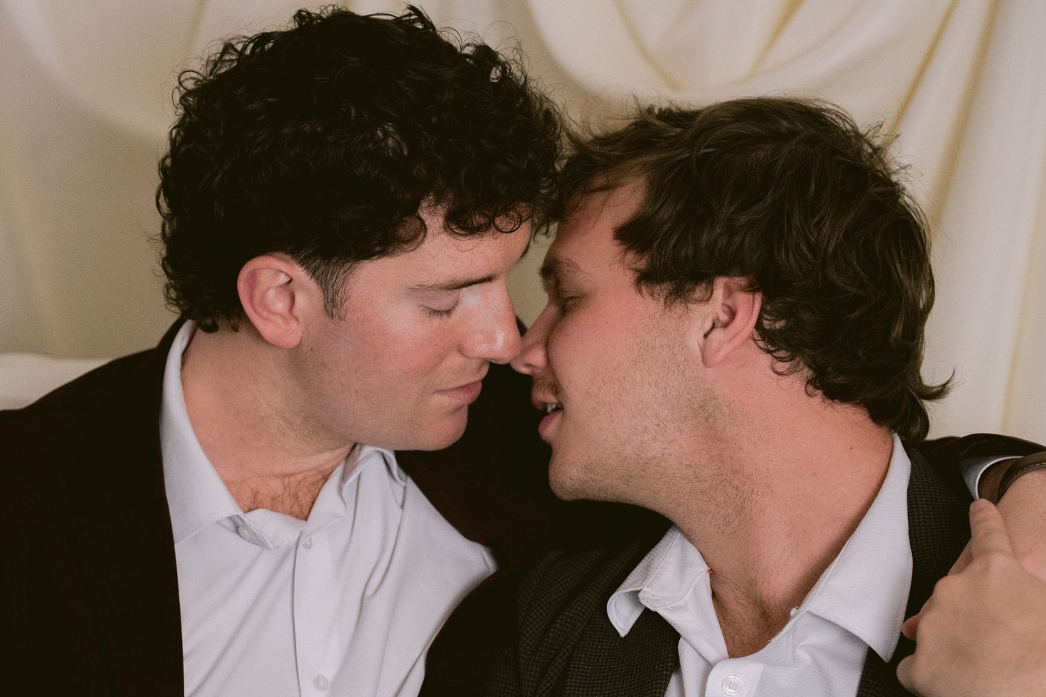 Two grooms almost kissing
