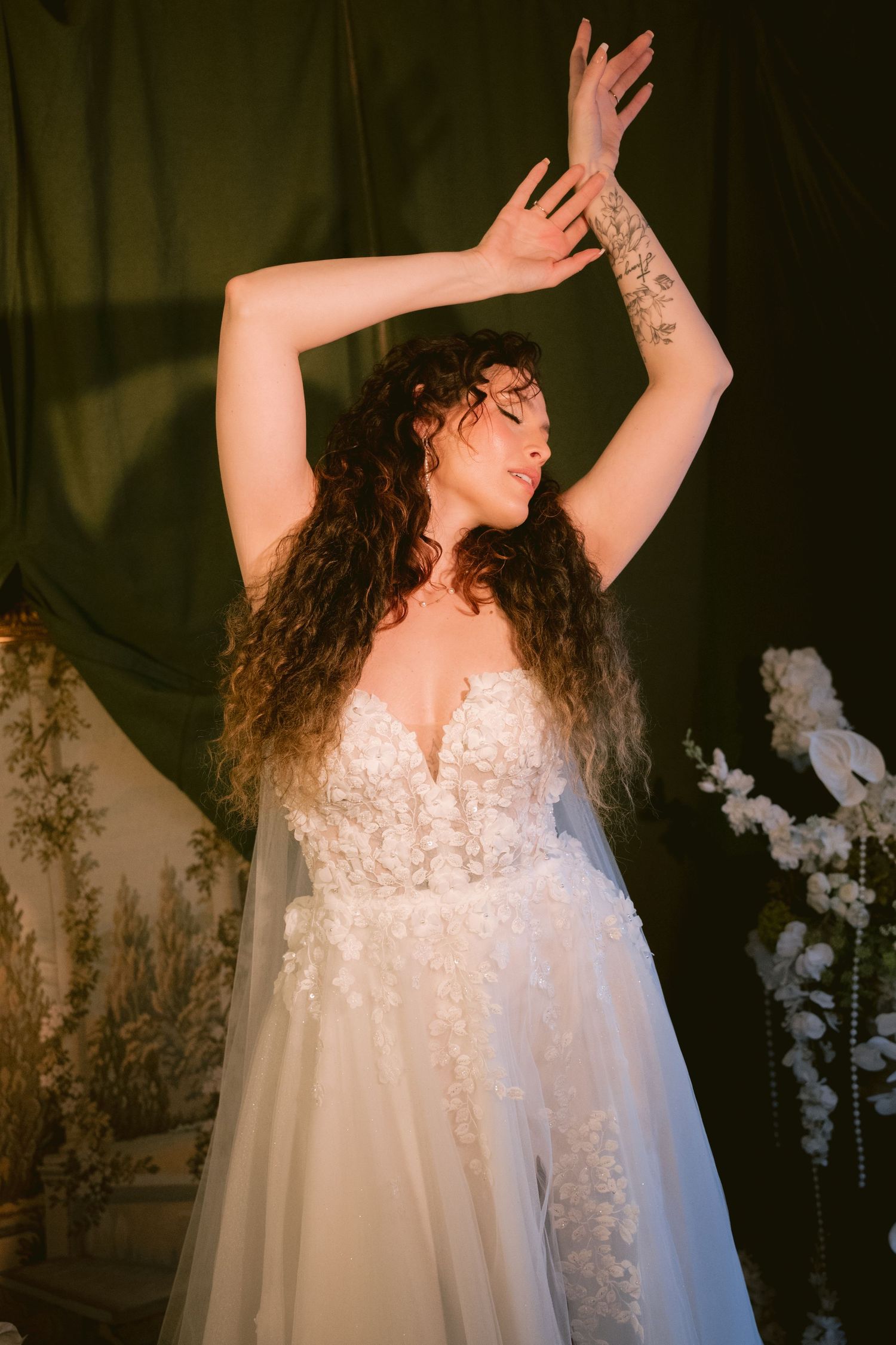 A bride posing with her arms raised