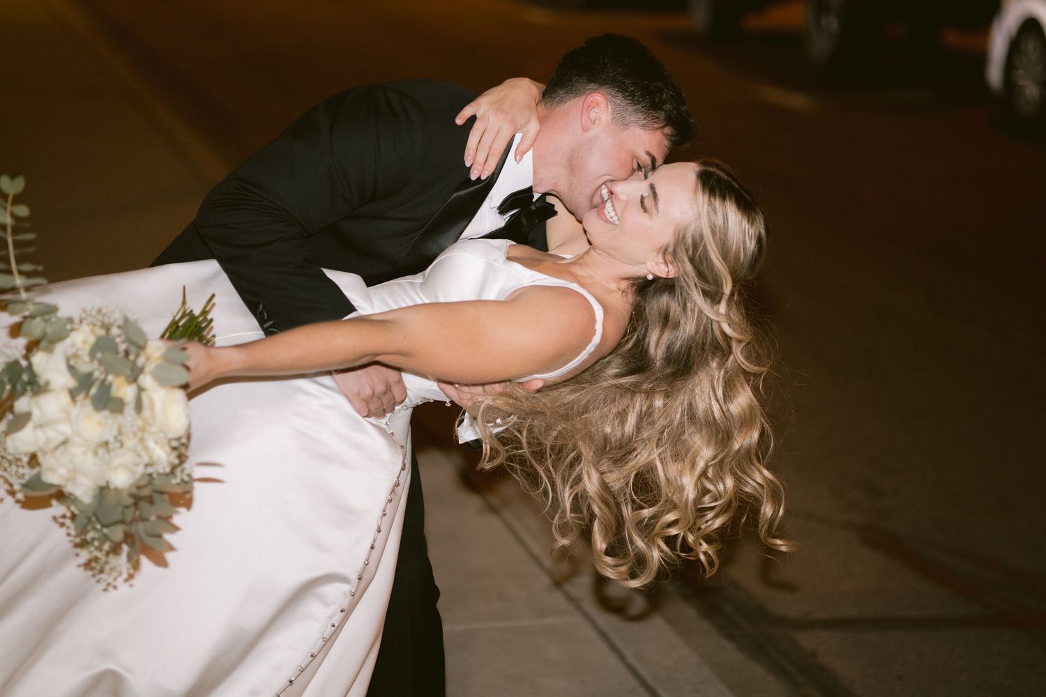 A newlywed couple kisses outside Clay Venues in Colorado Springs, CO