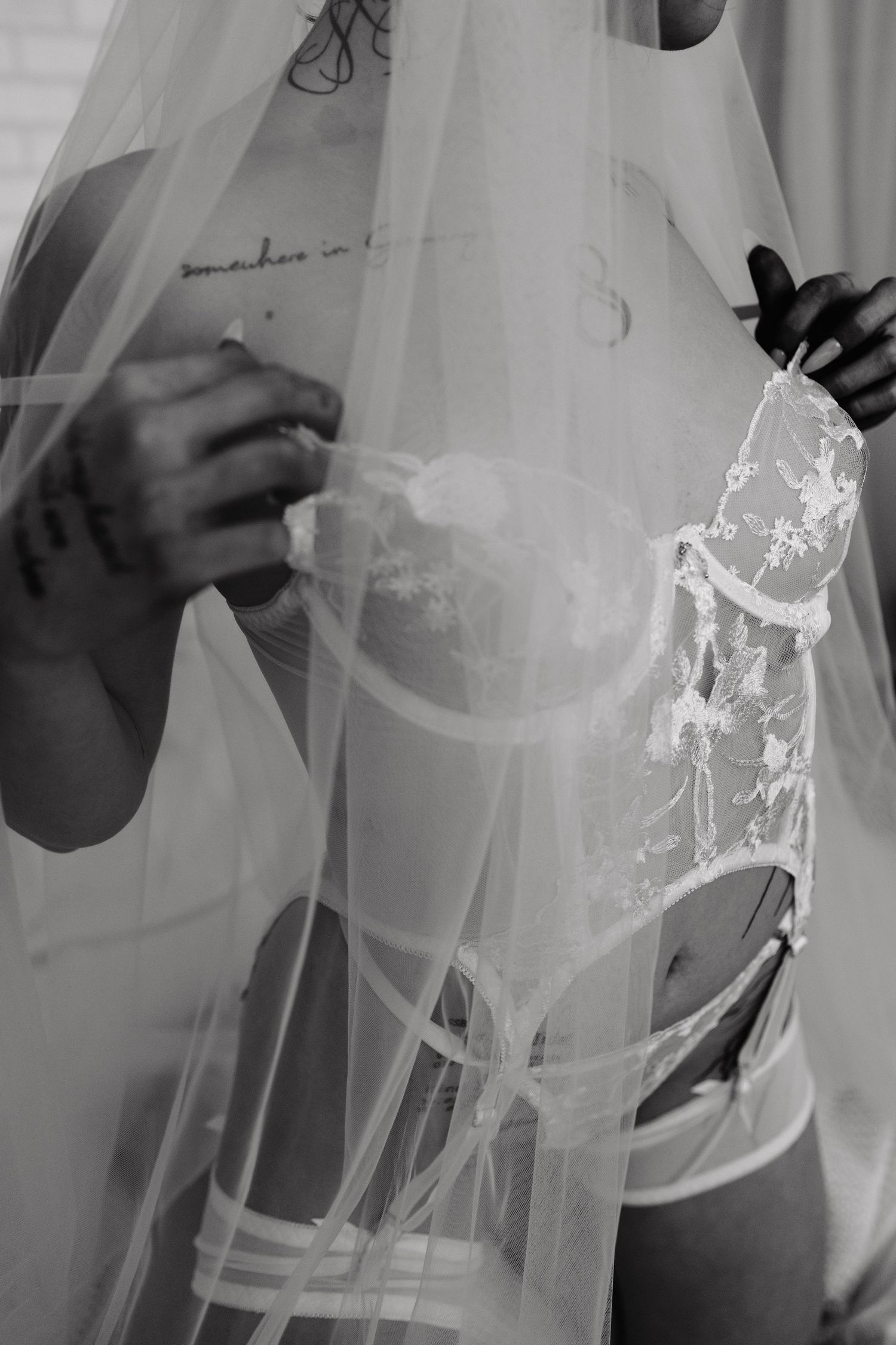 Bridal Boudoir photographer in Plattsmouth Nebraska in an intimate private studio. woman is posing in white lingerie