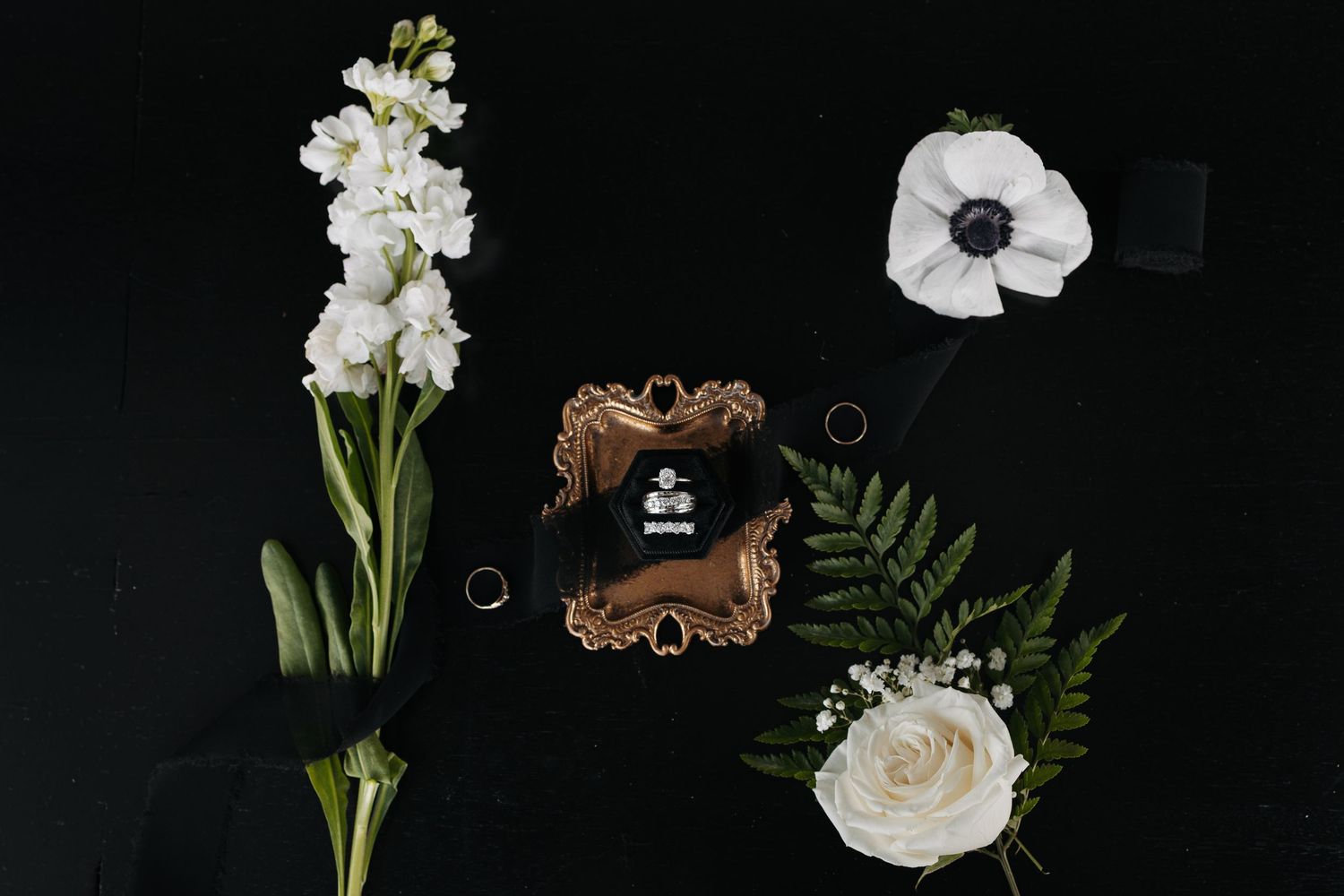 Detail layflat design with rings and fresh white florals luxury wedding photos Palmyra Nebraska at the acreage