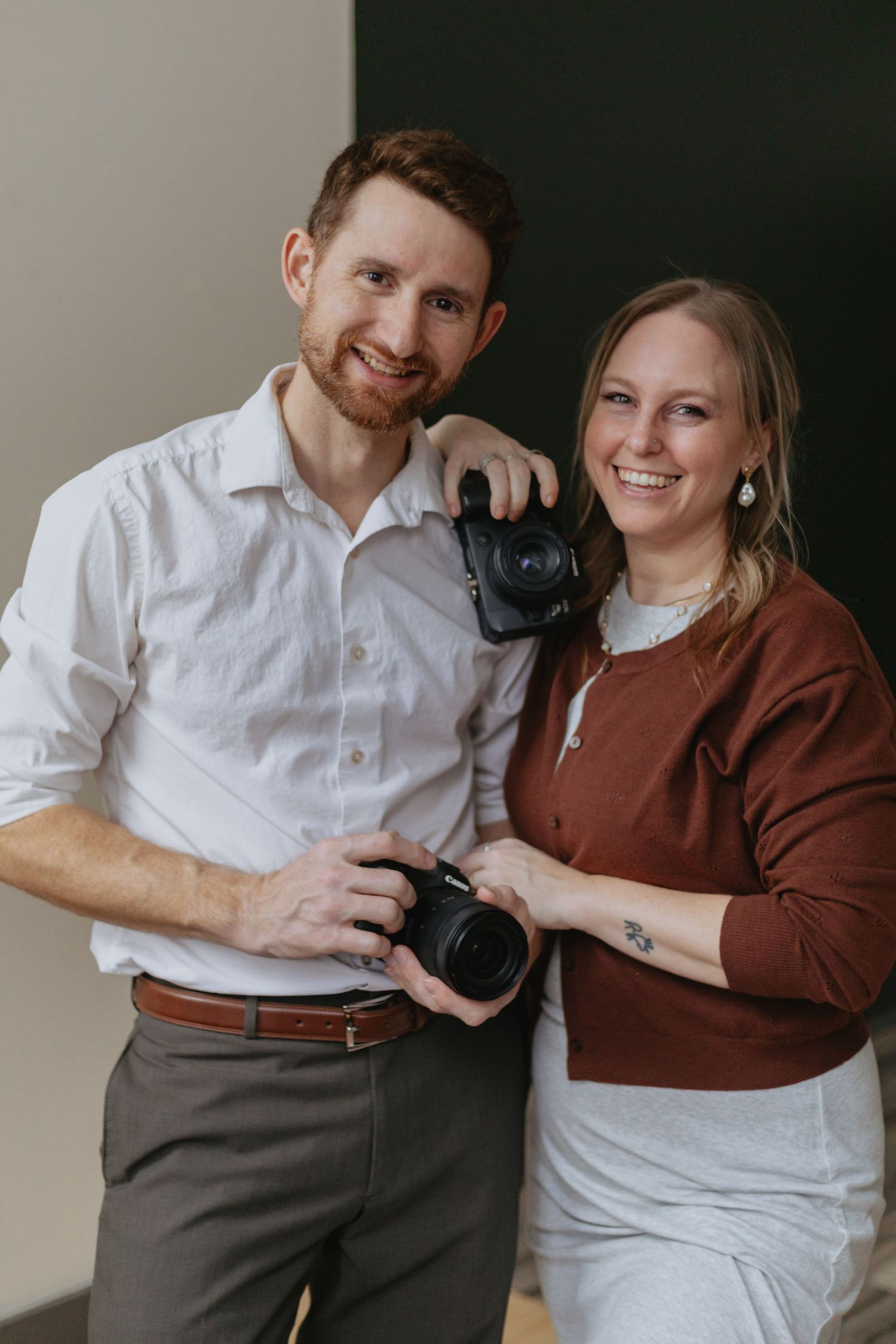 Wedding Photographers posing in studio. Kinsey Nixon-Bay and Matthew Bay