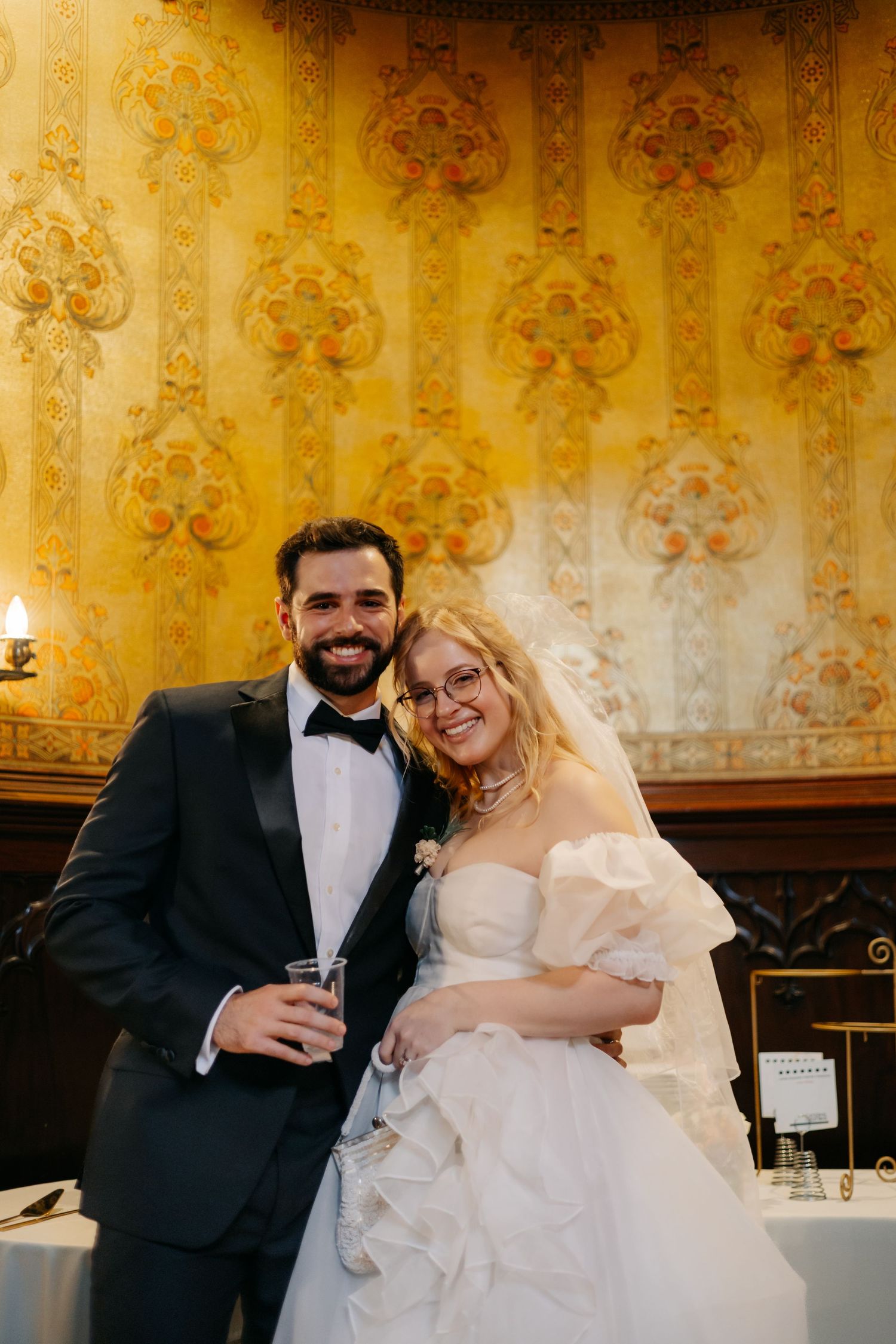 Indoor wedding reception setup at Joslyn Castle, historic Omaha venue with classic decor and candlelit ambiance.