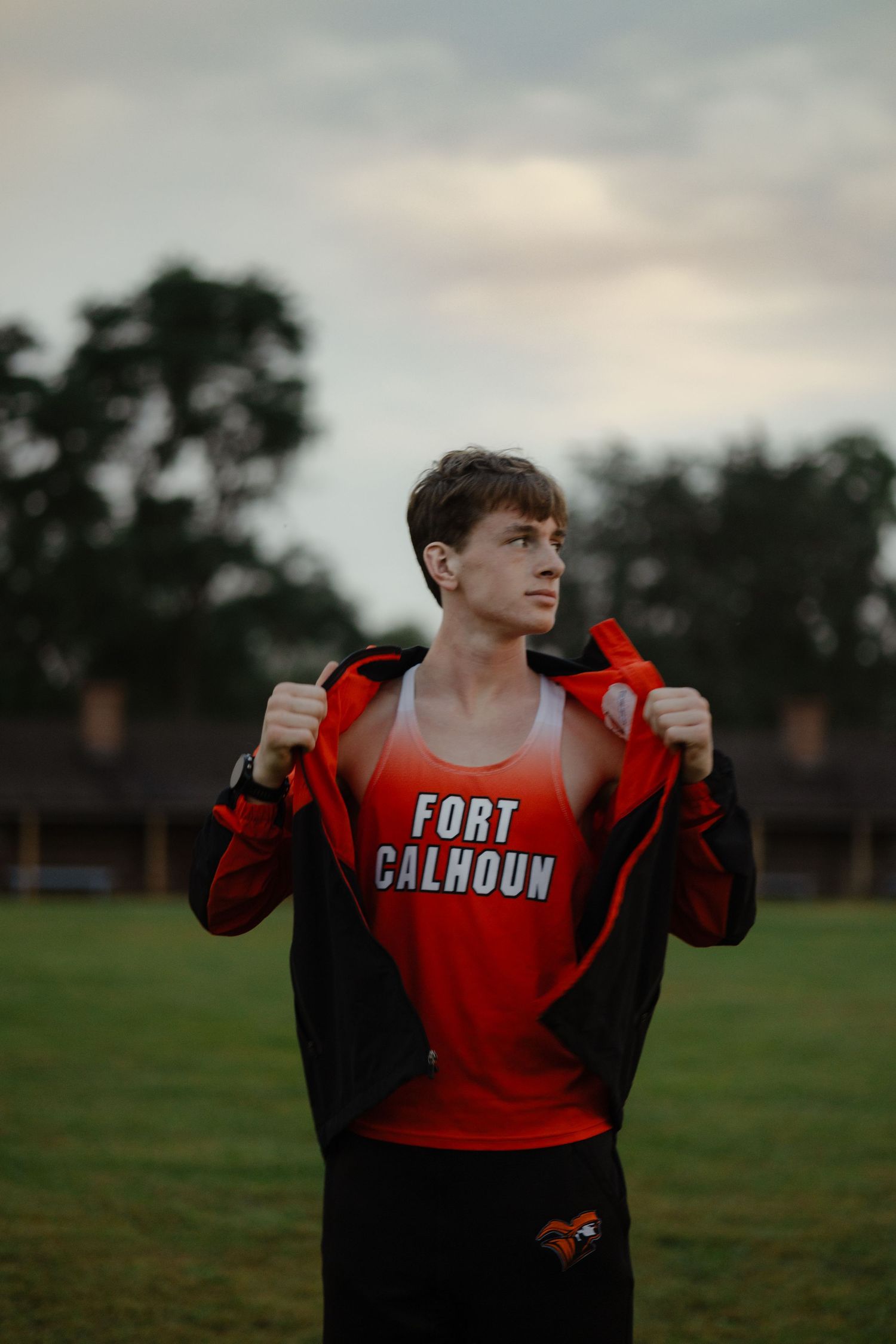 Nebraska senior portraits at sunset in open field in Fort Calhoun Nebraska
