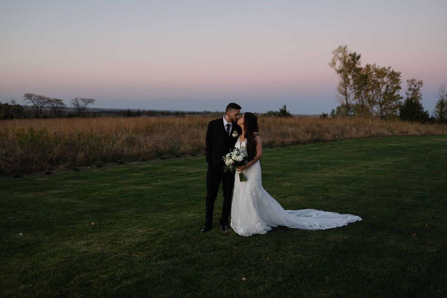 Blue hour portraits of the wedding couple at The Acreage in Palmyra Nebraska for a fall wedding.