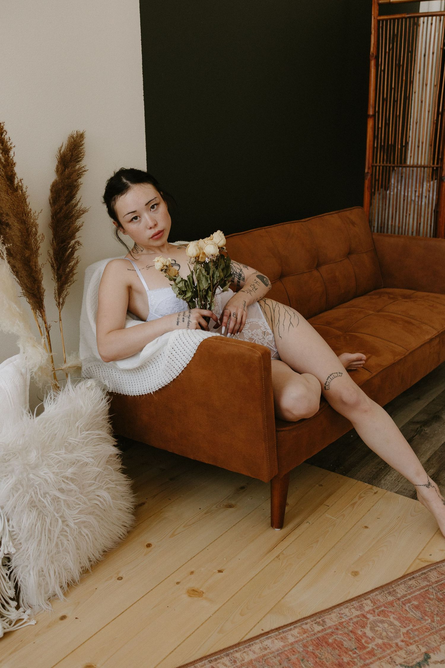 Woman posing in white lingerie in a private studio in Plattsmouth Nebraska for a bridal boudoir session