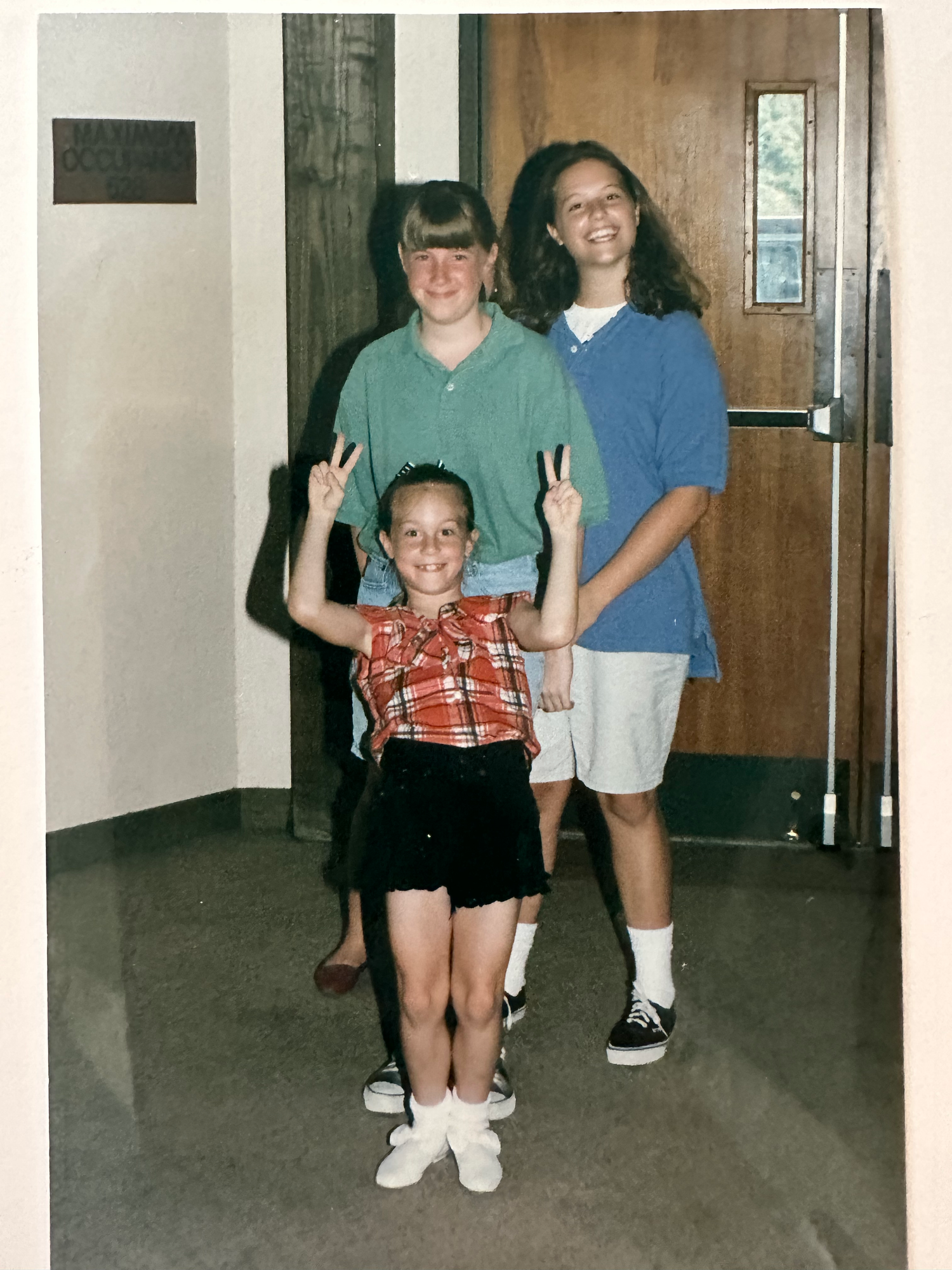 Three vintage photographs show people posing in a hallway with various casual stances and clothing from the 1990s era.
