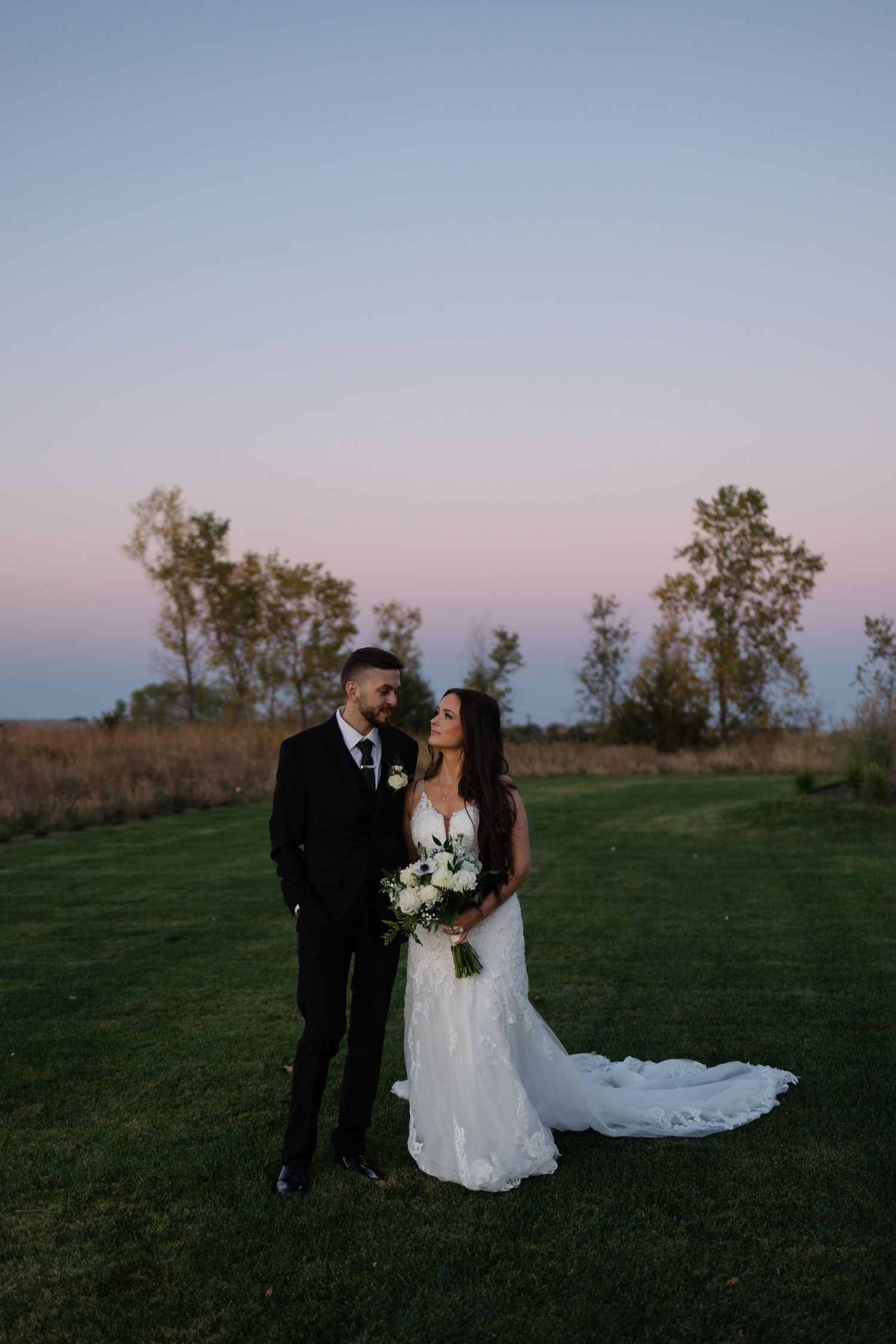 Blue hour portraits of the wedding couple at The Acreage in Palmyra Nebraska for a fall wedding.