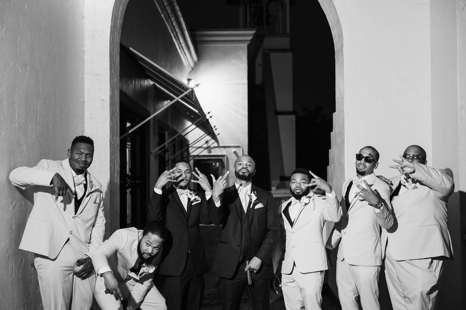 Groom portrait with groomsmen in matching suits