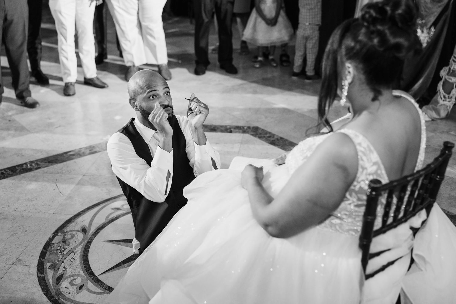 Bride in lace wedding gown with groom in black tuxedo