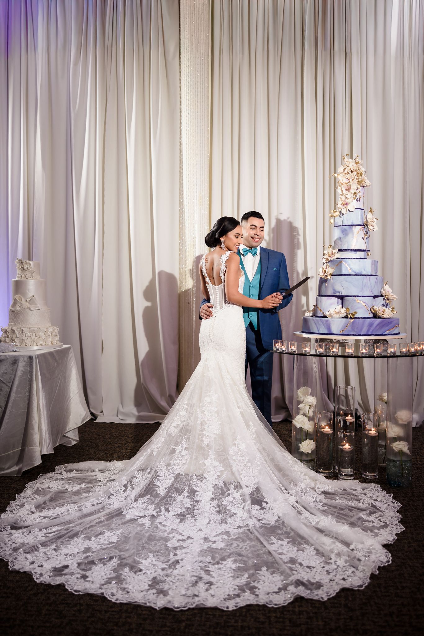 Couple cutting wedding cake at reception