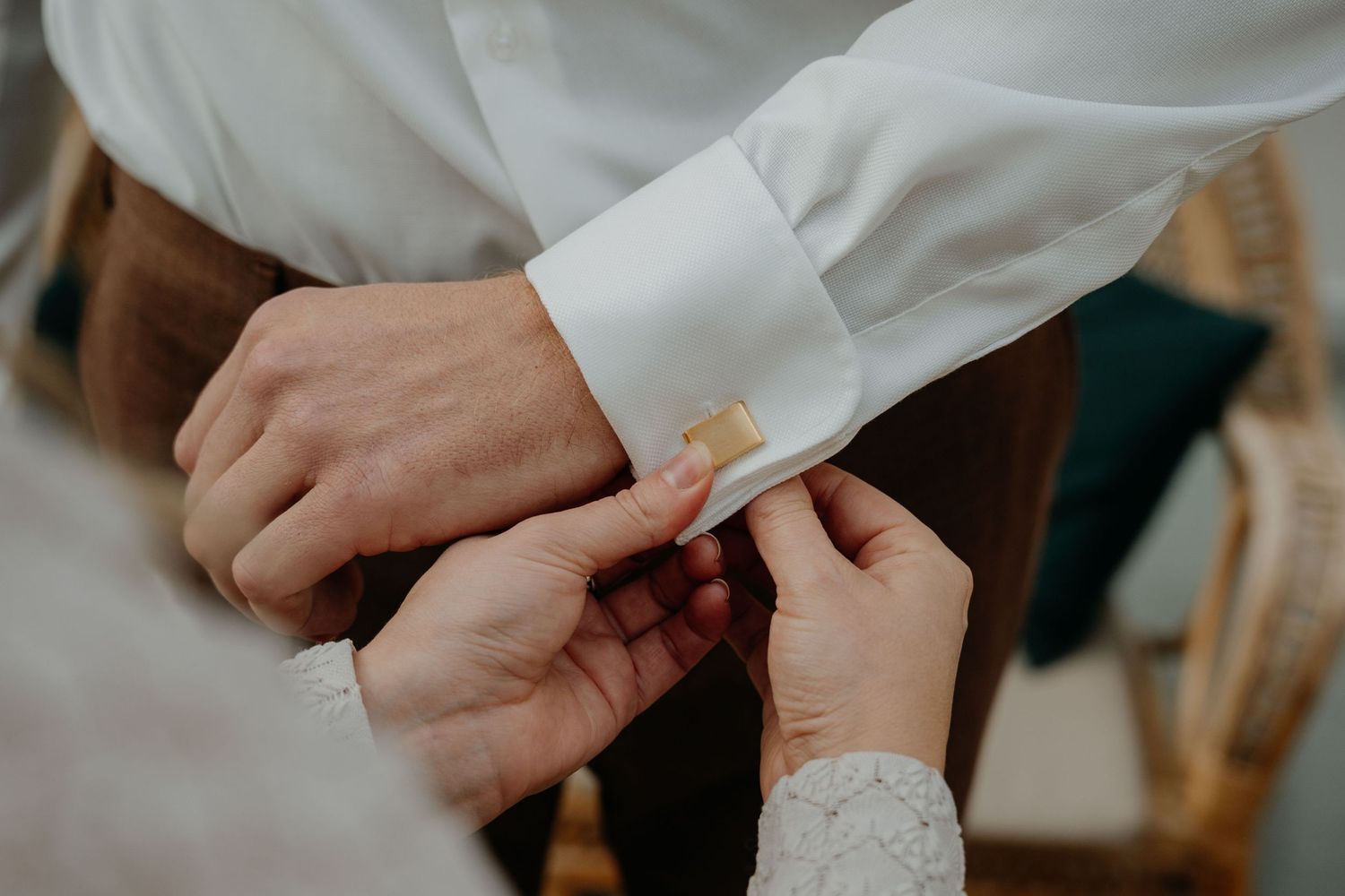 Close-up view of hands exchanging business cards during a professional meeting.