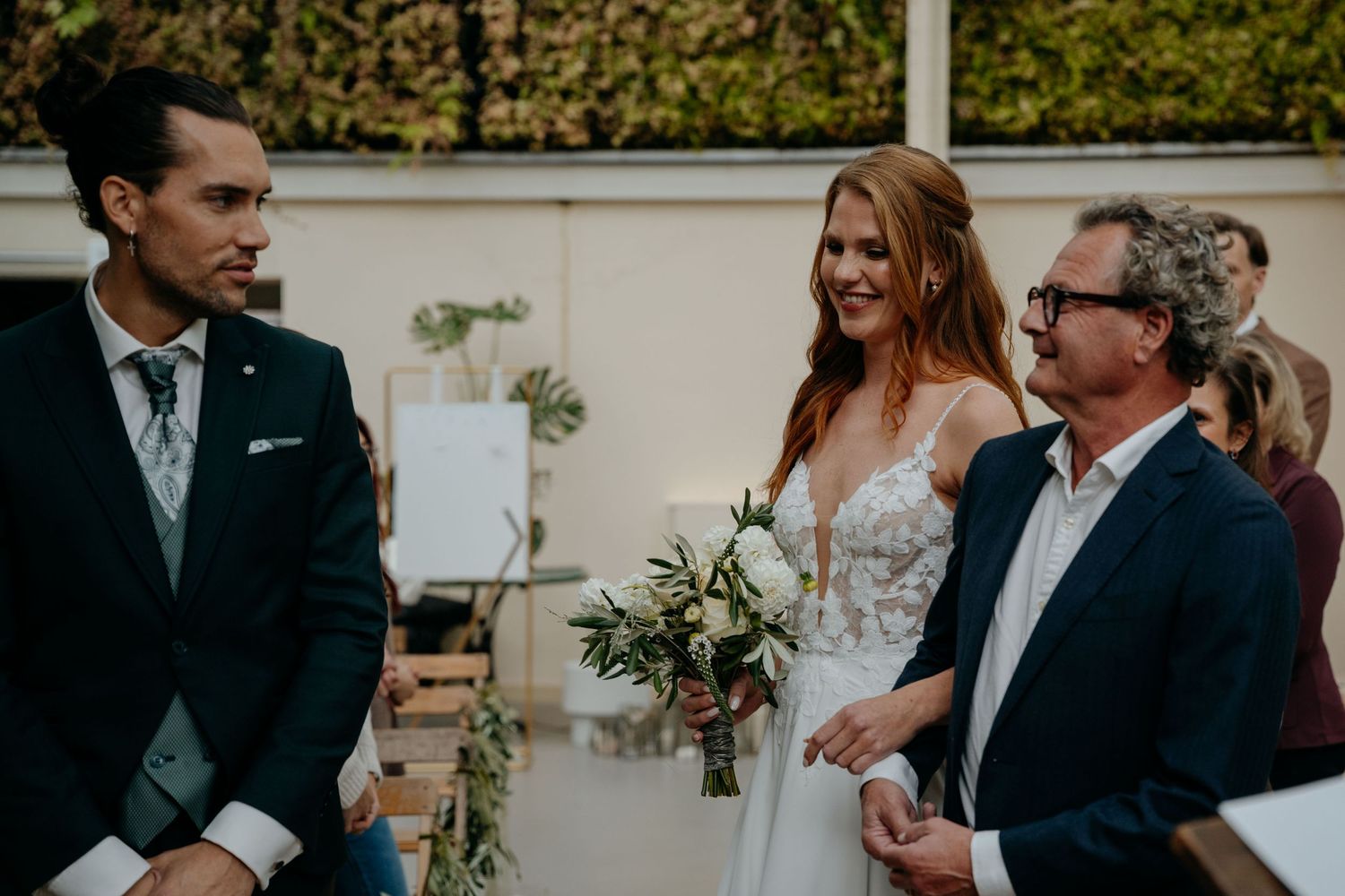A wedding couple and their guests share joyful moments during an outdoor garden ceremony celebration.