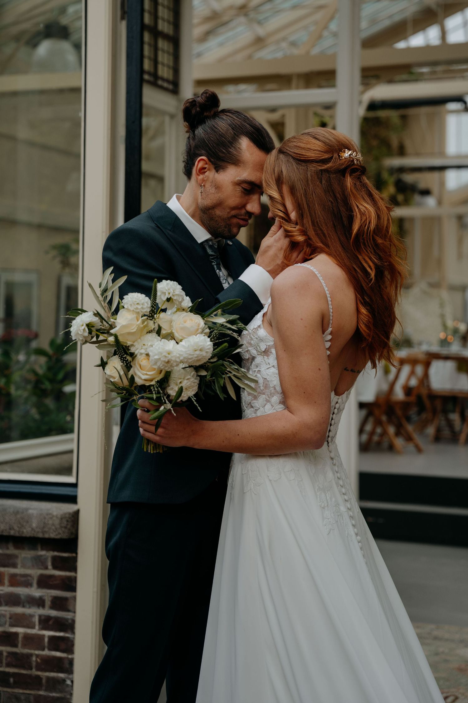 Romantic wedding couple sharing intimate moments in multiple candid poses while holding a white floral bouquet.