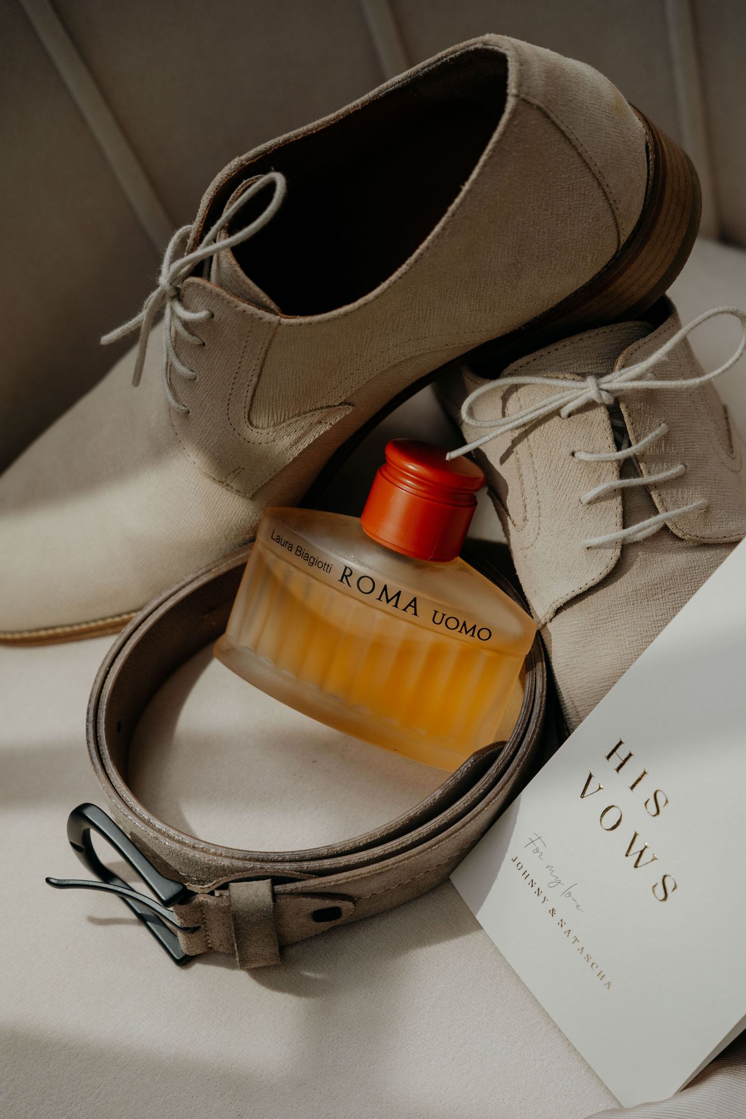 A series of beige leather dress shoes photographed with product tags and orange packaging in an artistic layout.