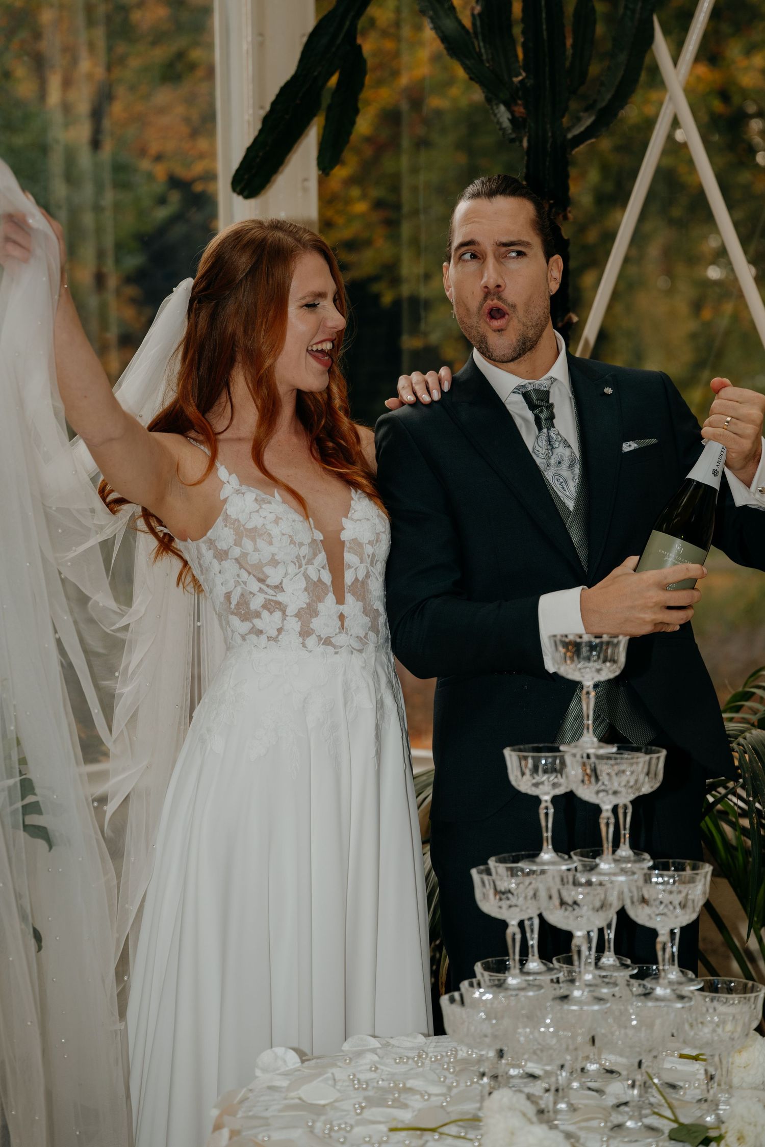 Wedding celebration scene with champagne glasses and elegant decor in natural light.