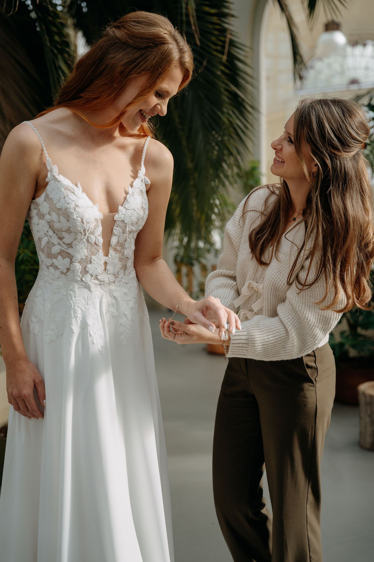 Detail shots of a white lace wedding dress with delicate straps and floral appliques.