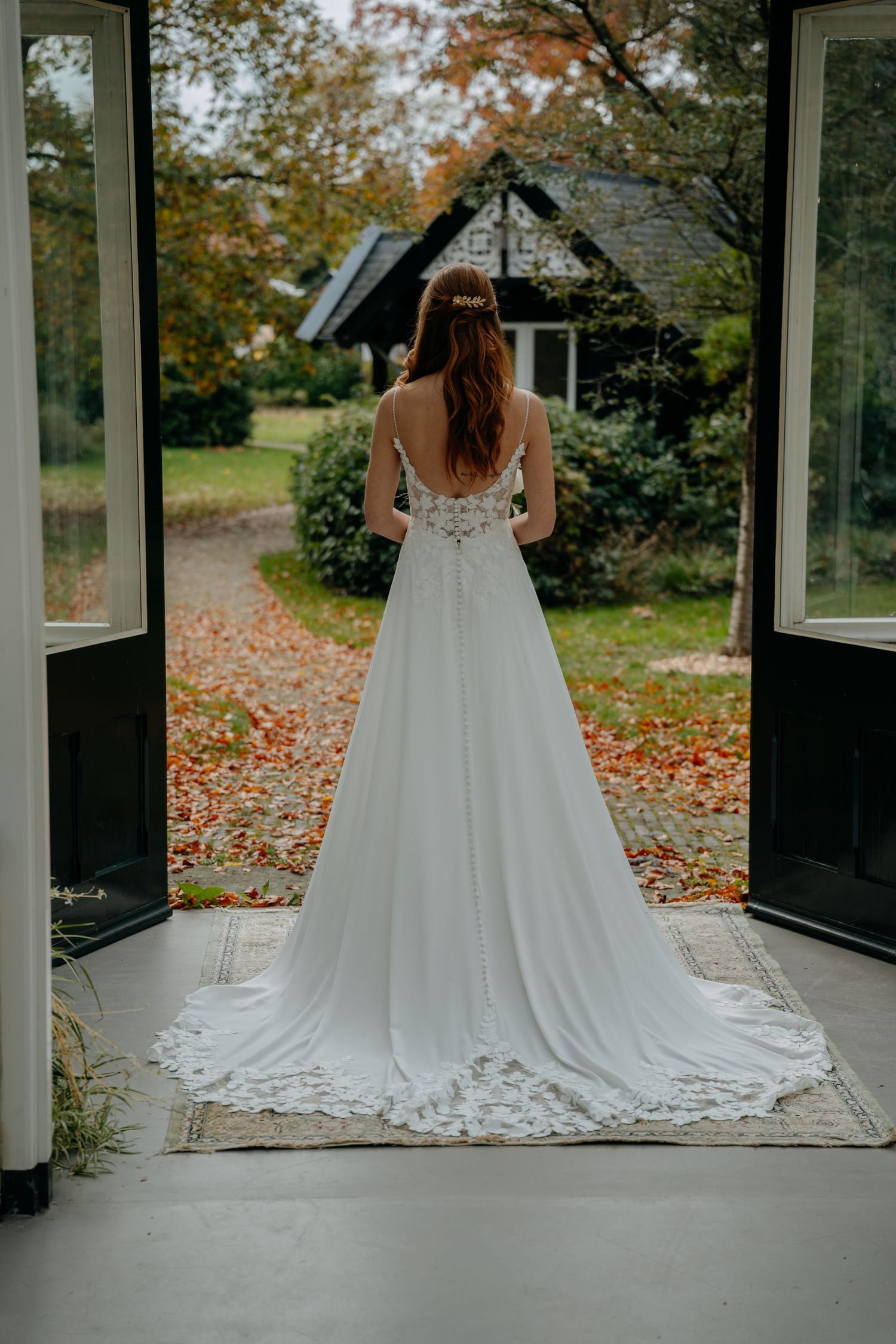 Wedding dress train details shown in sequence across glass conservatory with autumn leaves outside.