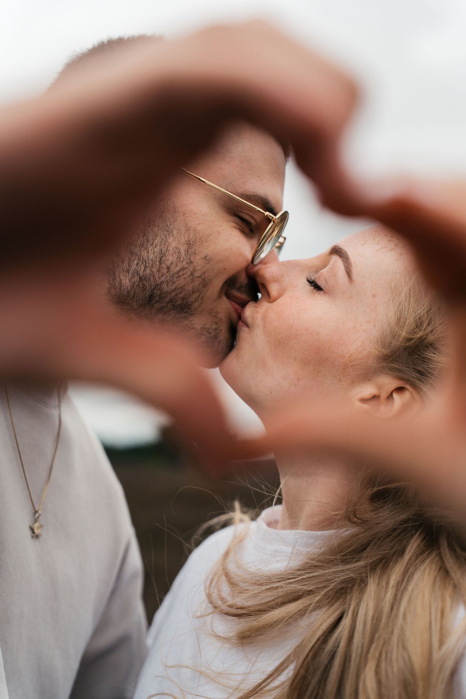 Artistic profile shots showing intimate romantic moments in soft natural lighting.