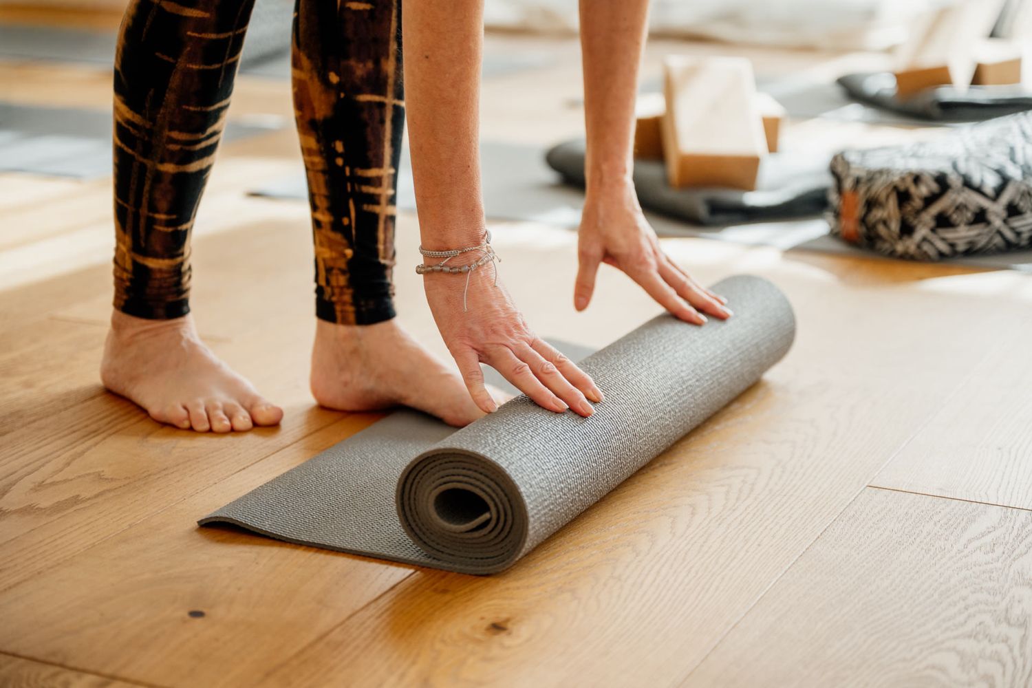 Yogamatte wird auf dem Boden ausgerollt