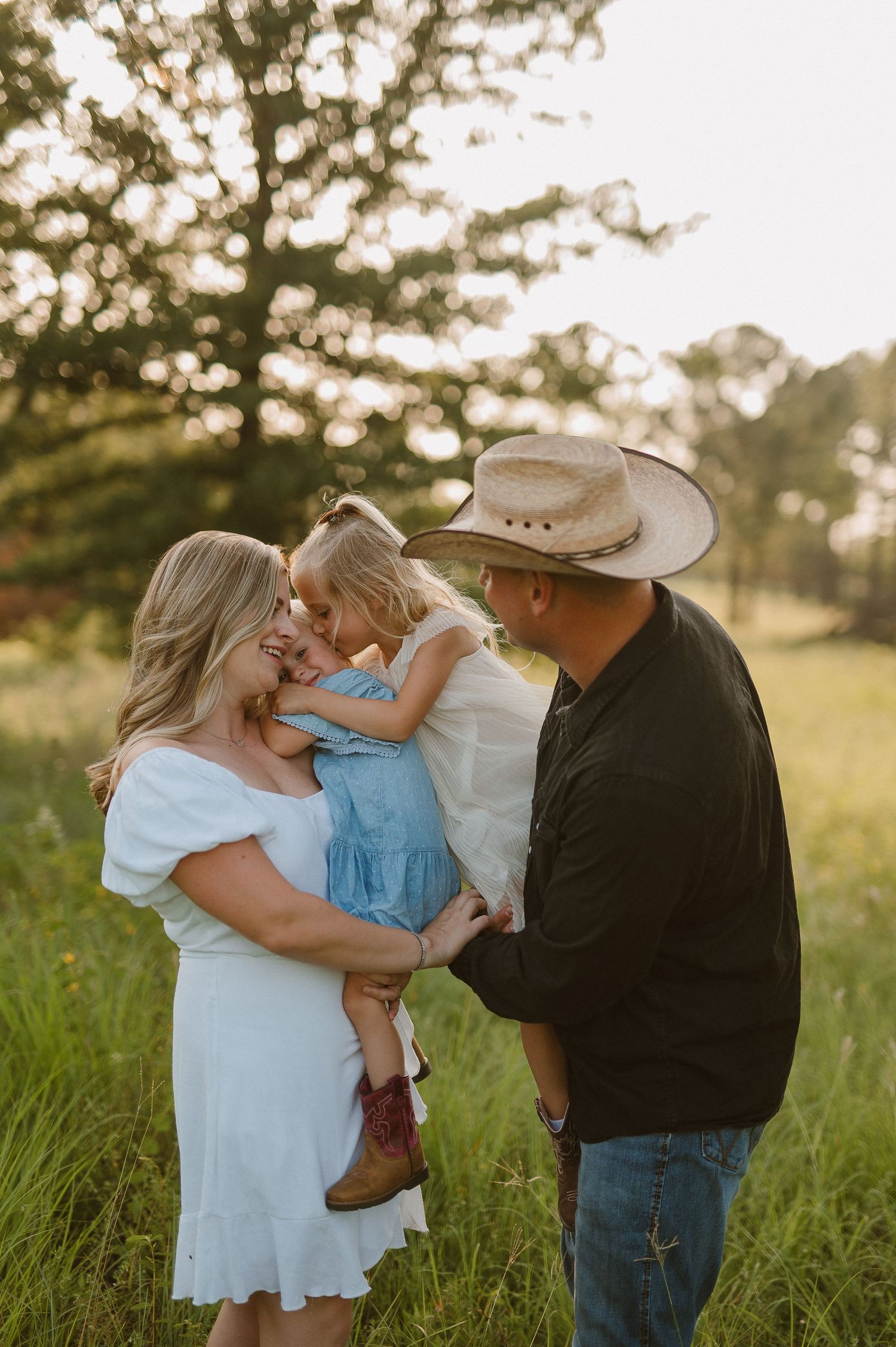 Parents holding child during outdoor family portraits in Alvord, Tx