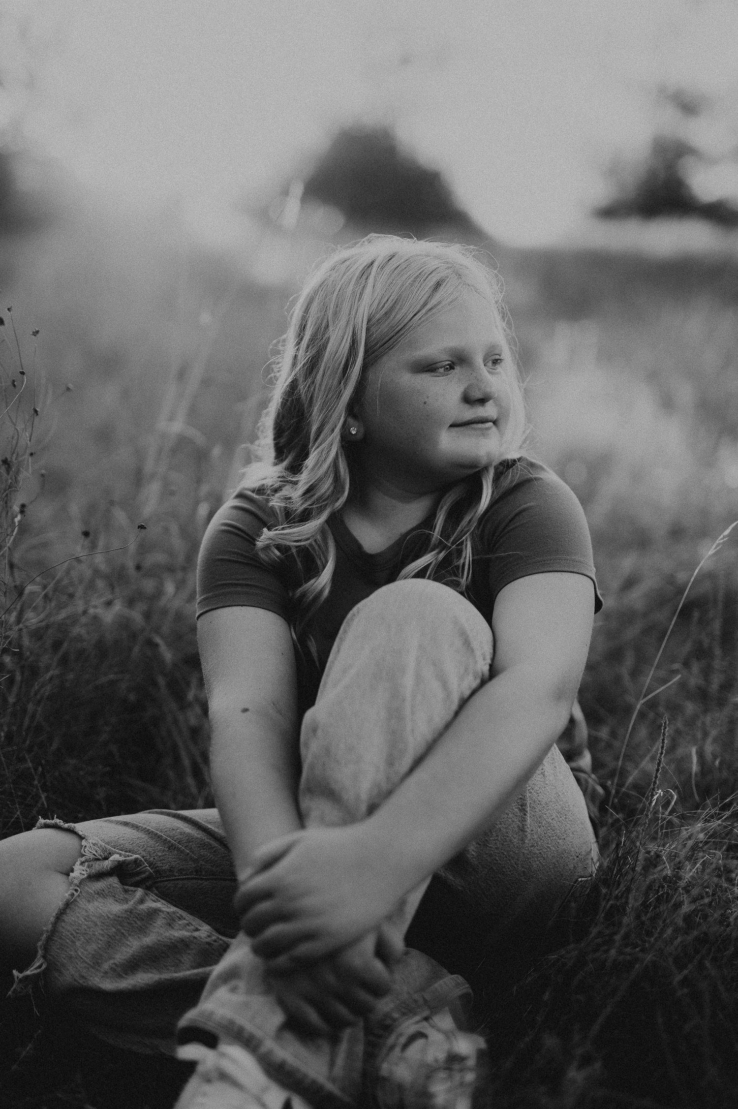 Young girl portrait sitting in a field of grass in Lake Worth, Tx