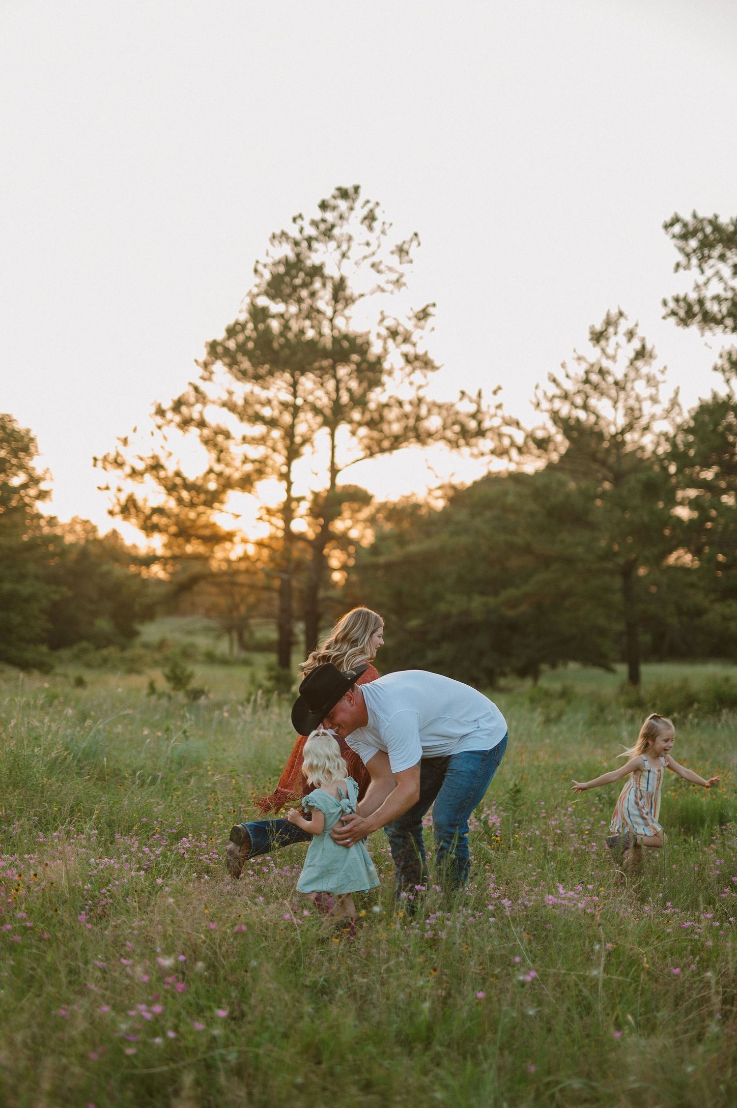 Parents chasing children during a family session in Alvord, Tx