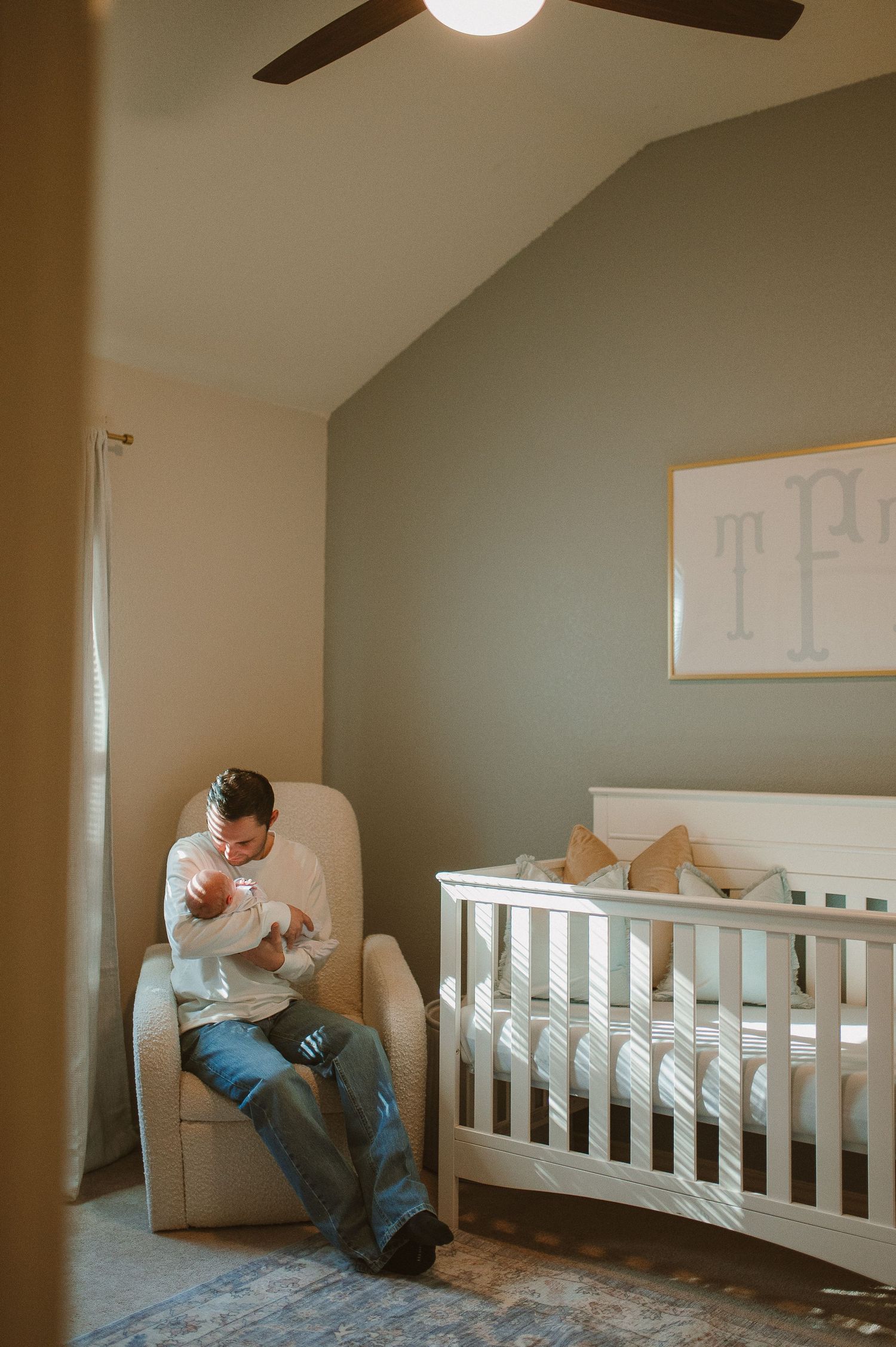 Lifestyle newborn session with dad and baby in nursery