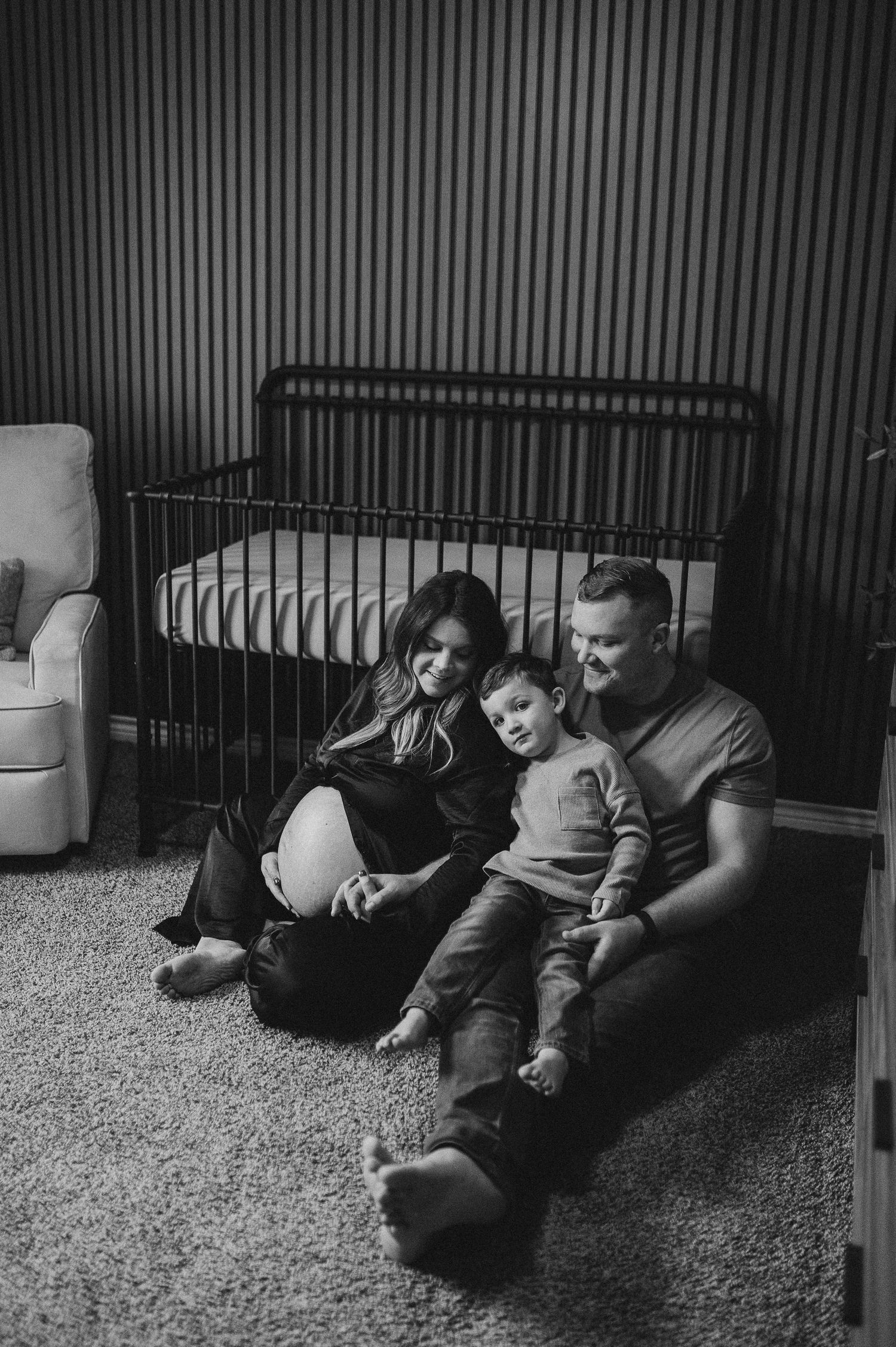Family sitting together during indoor maternity session