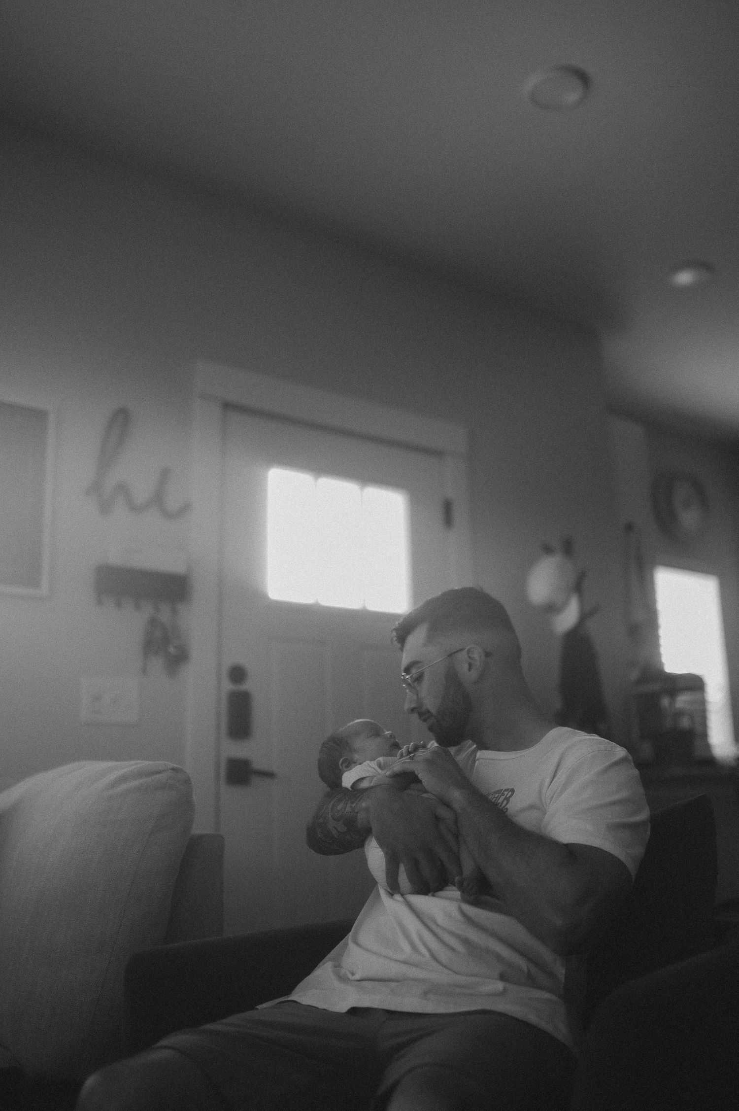 Dad holding baby during a newborn lifestyle session in Fort Worth, TX