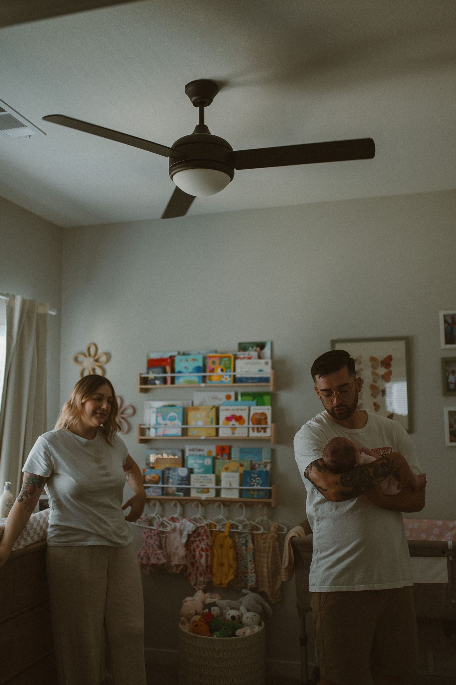 Parents holding baby indoors during lifestyle family session in Fort Worth, tx