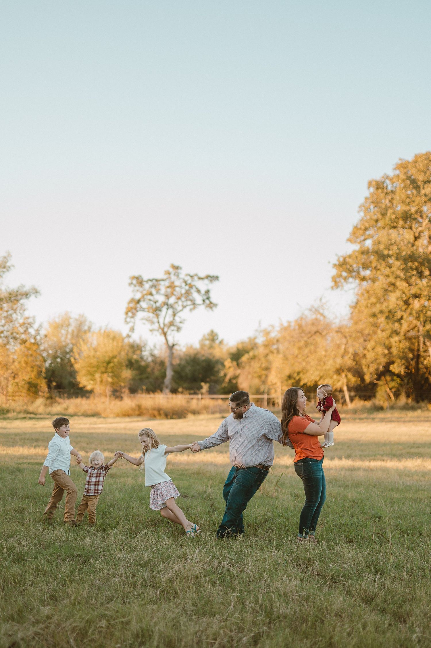 Family of six playing a game in a field in Weatherford, Tx