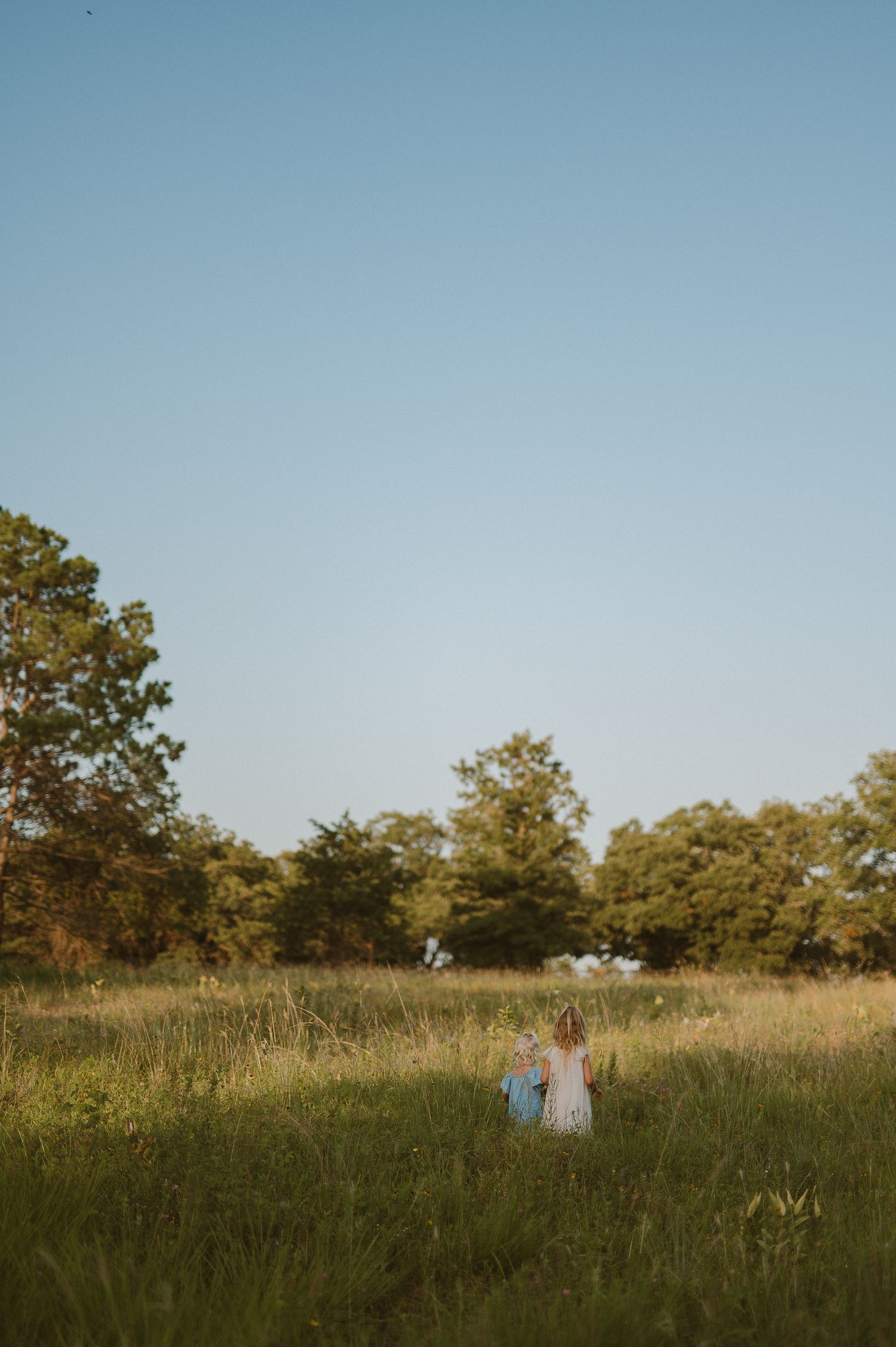 Sisters walking together in a field in Fort Worth, Tx