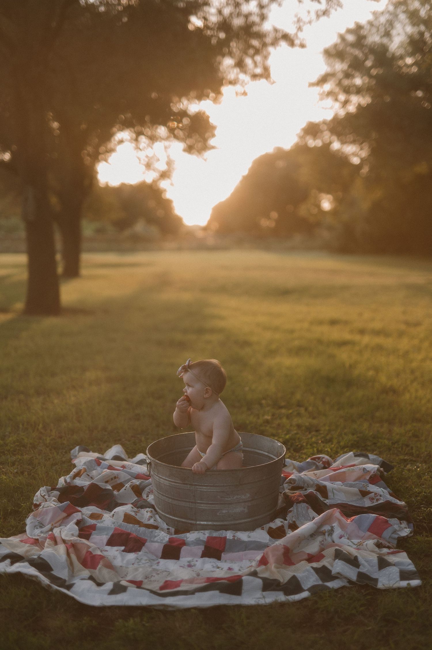 Baby in a metal tub with strawberries during one year photoshoot