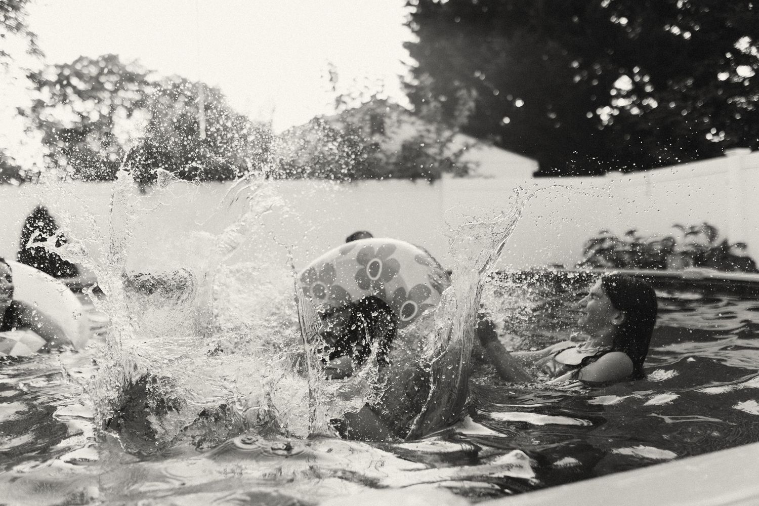 A sequence of splashing water droplets captured in motion against a light background.