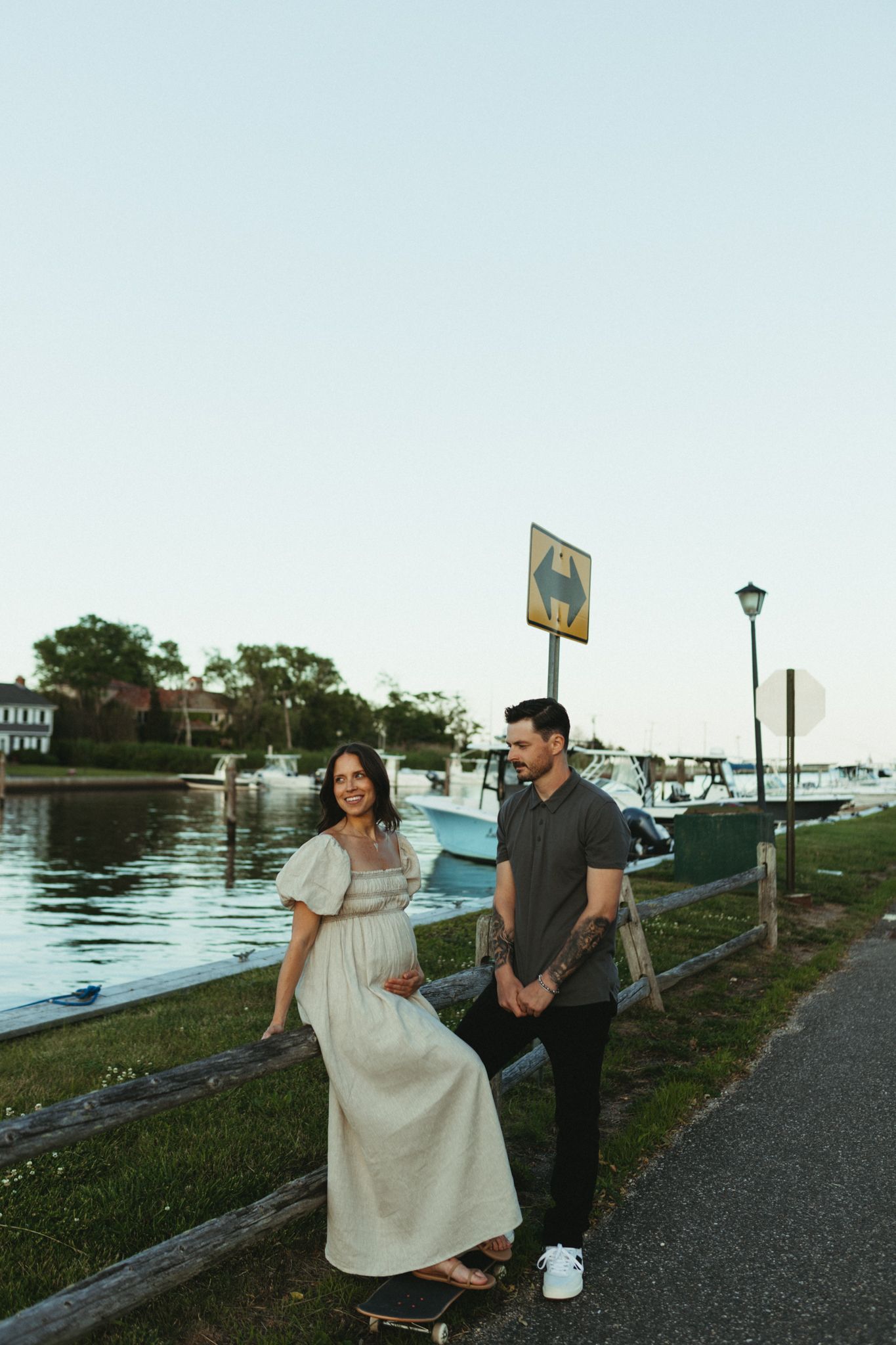 A couple enjoying time together on a waterfront path during golden hour.
