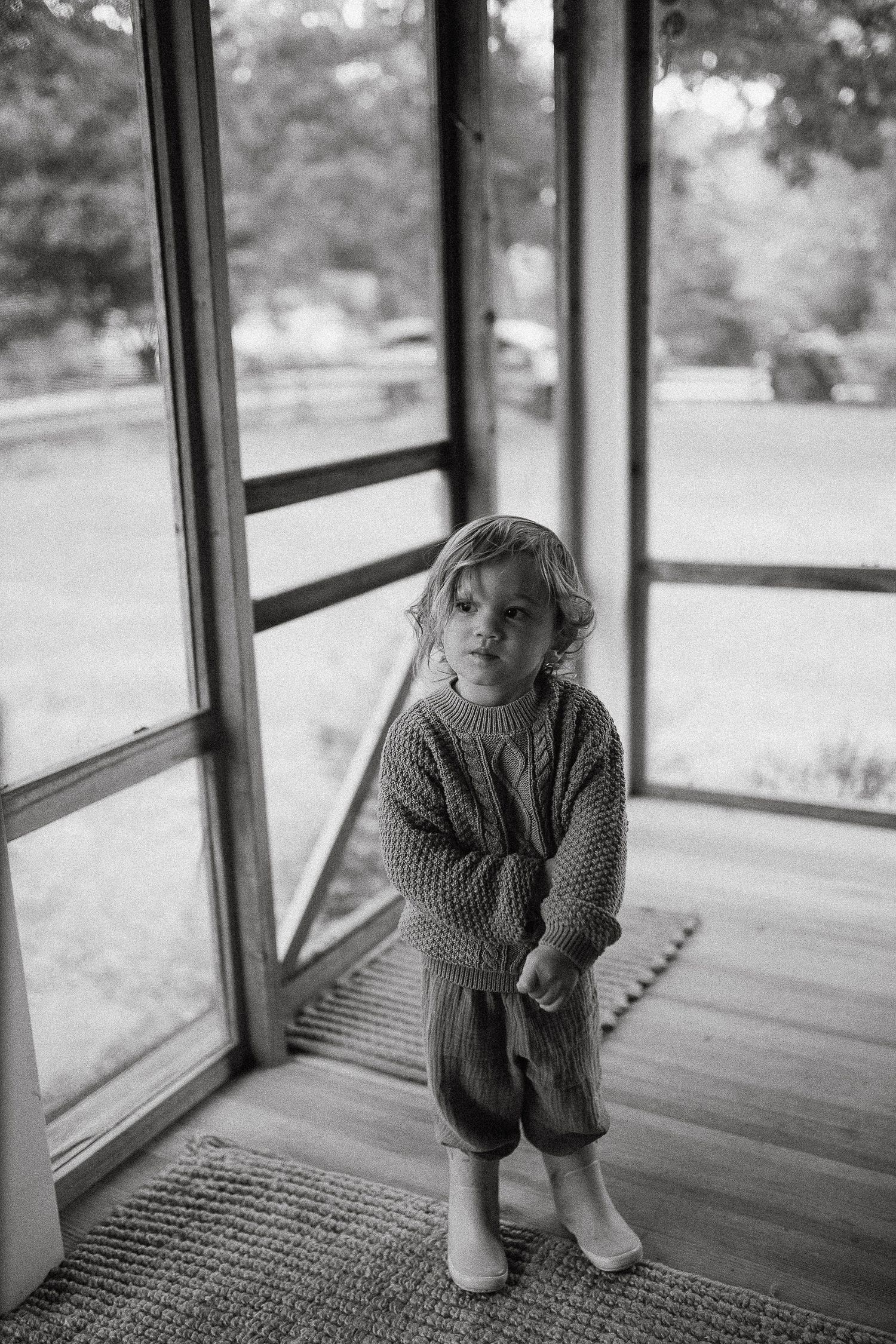 Black and white series showing contemplative moments on a screened porch.
