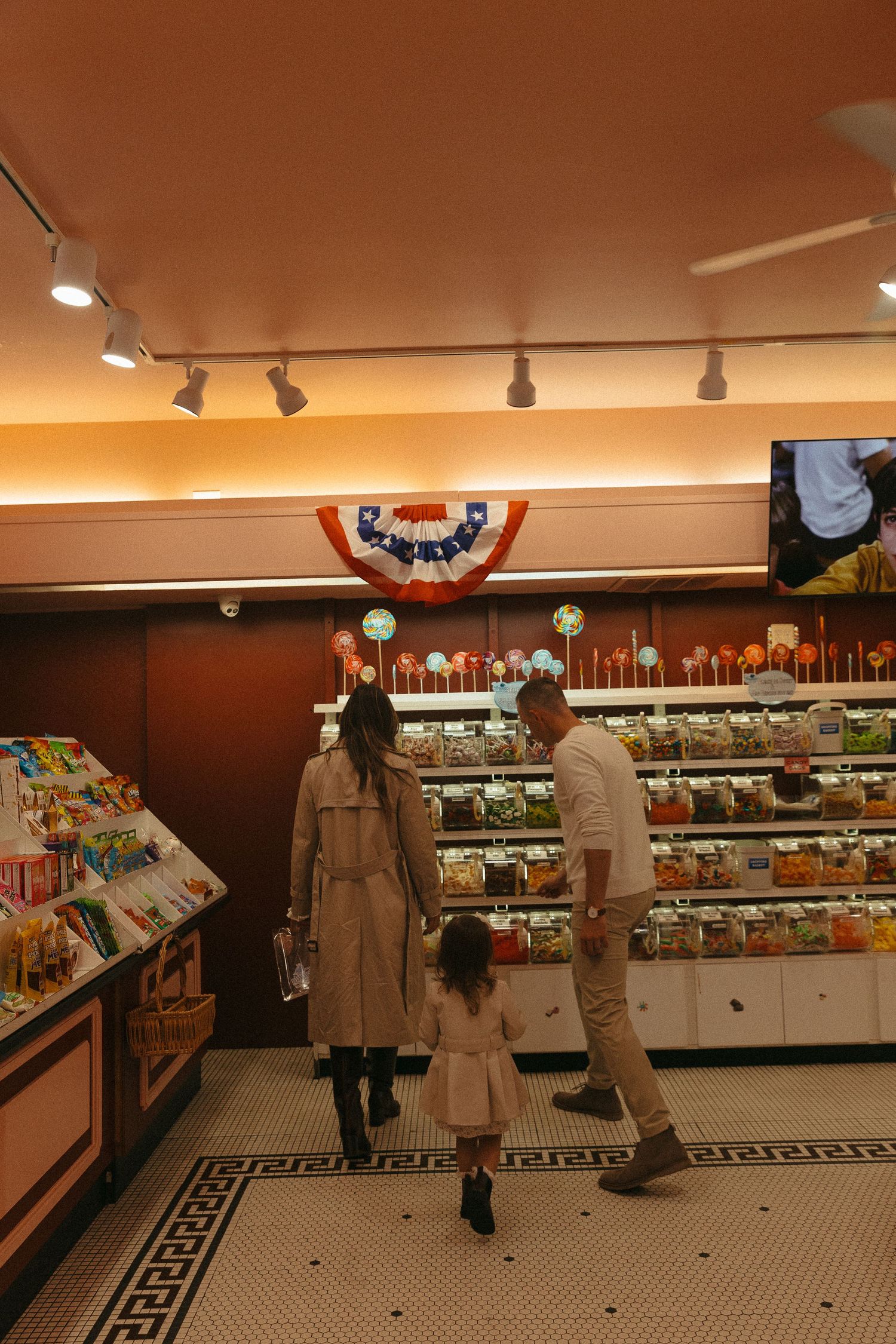 Retro-style candy store interior with tiled floor and illuminated display cases.