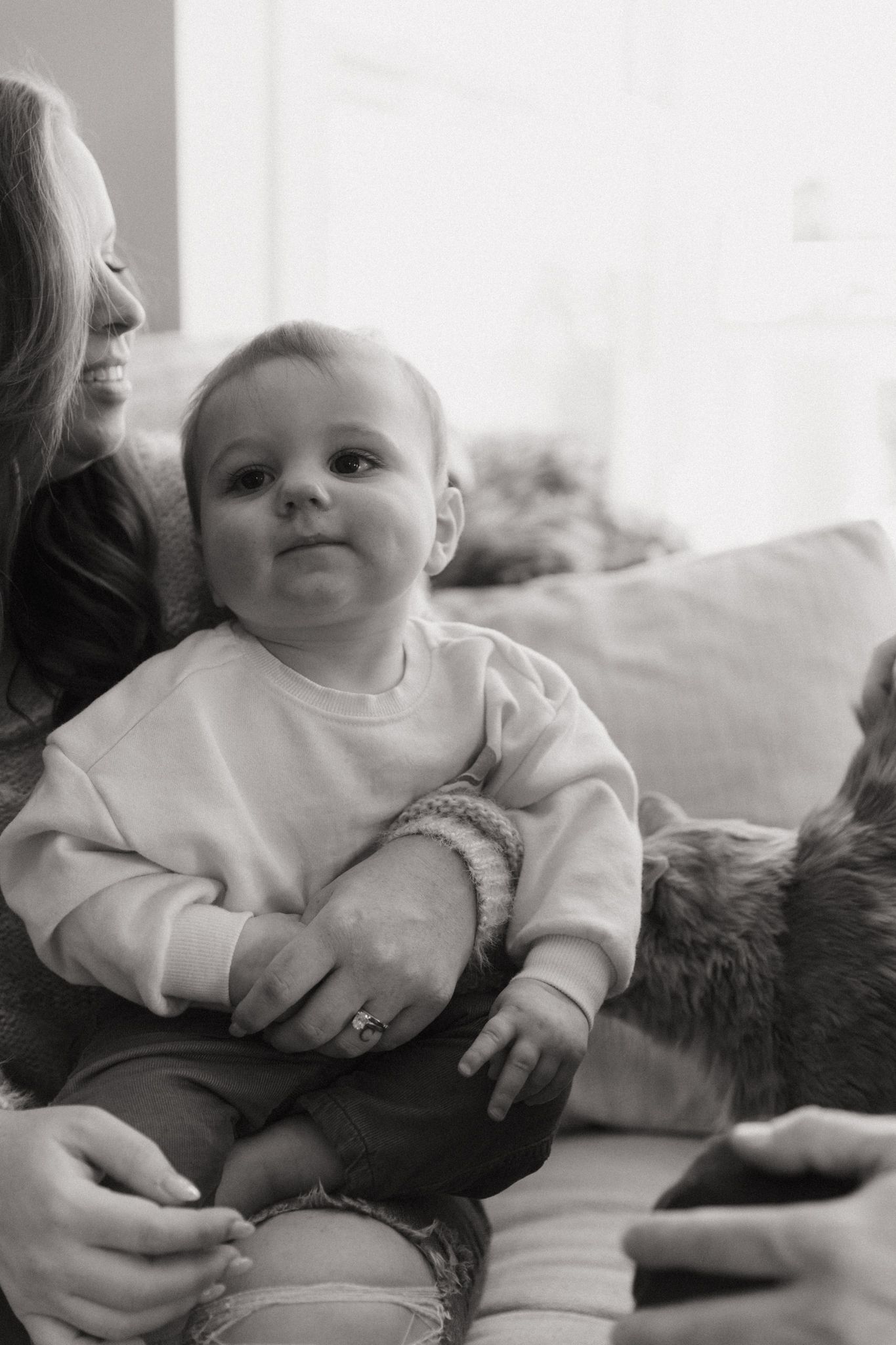 Black and white photos showing a baby resting on a soft surface.