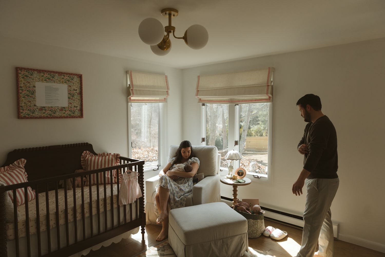 Sunlit nursery room interior with wooden crib and modern minimalist decor.